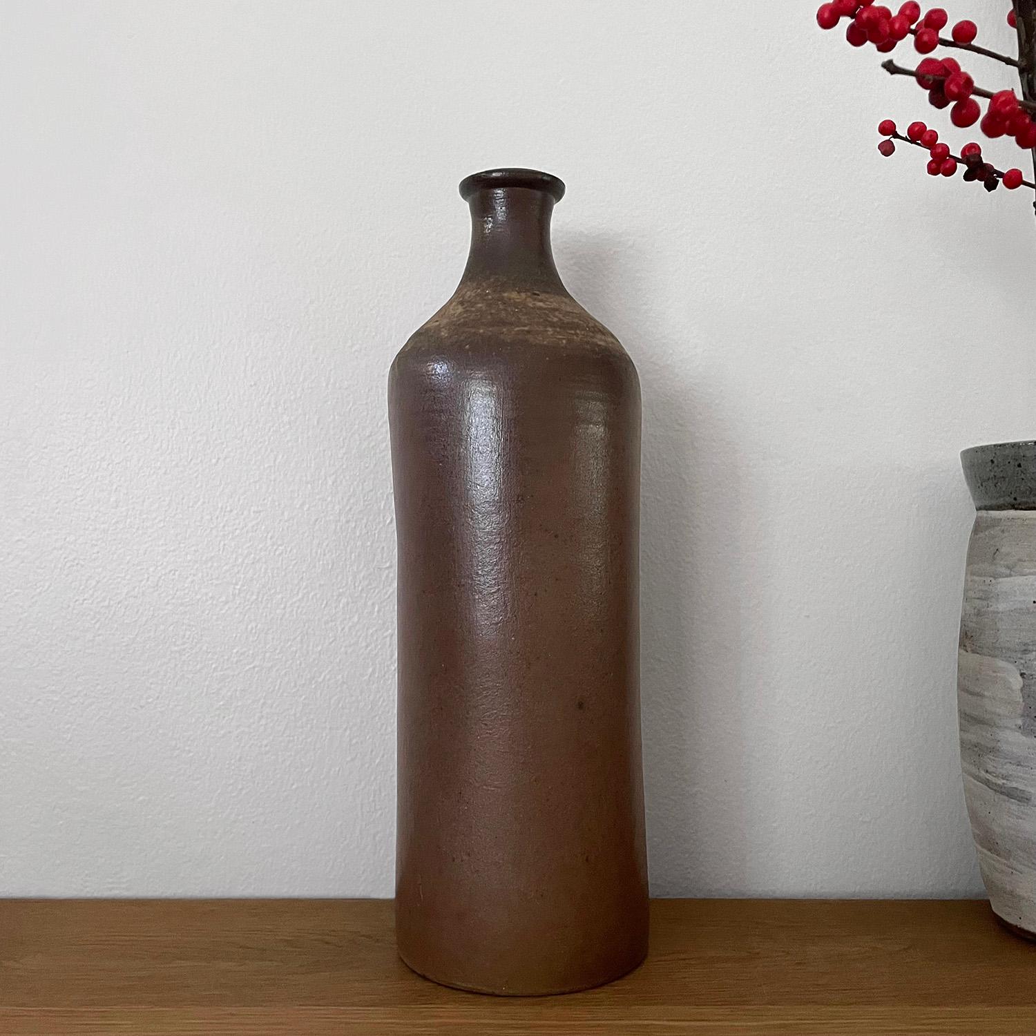 French ceramic stoneware bottle vase
Neutral toned ceramic stoneware ceramic bottle 
Organic composition and feel
This large bottle is grand in scale and substantial enough to hold a sunflower 
Vessel has not been tested to hold water
Patina from