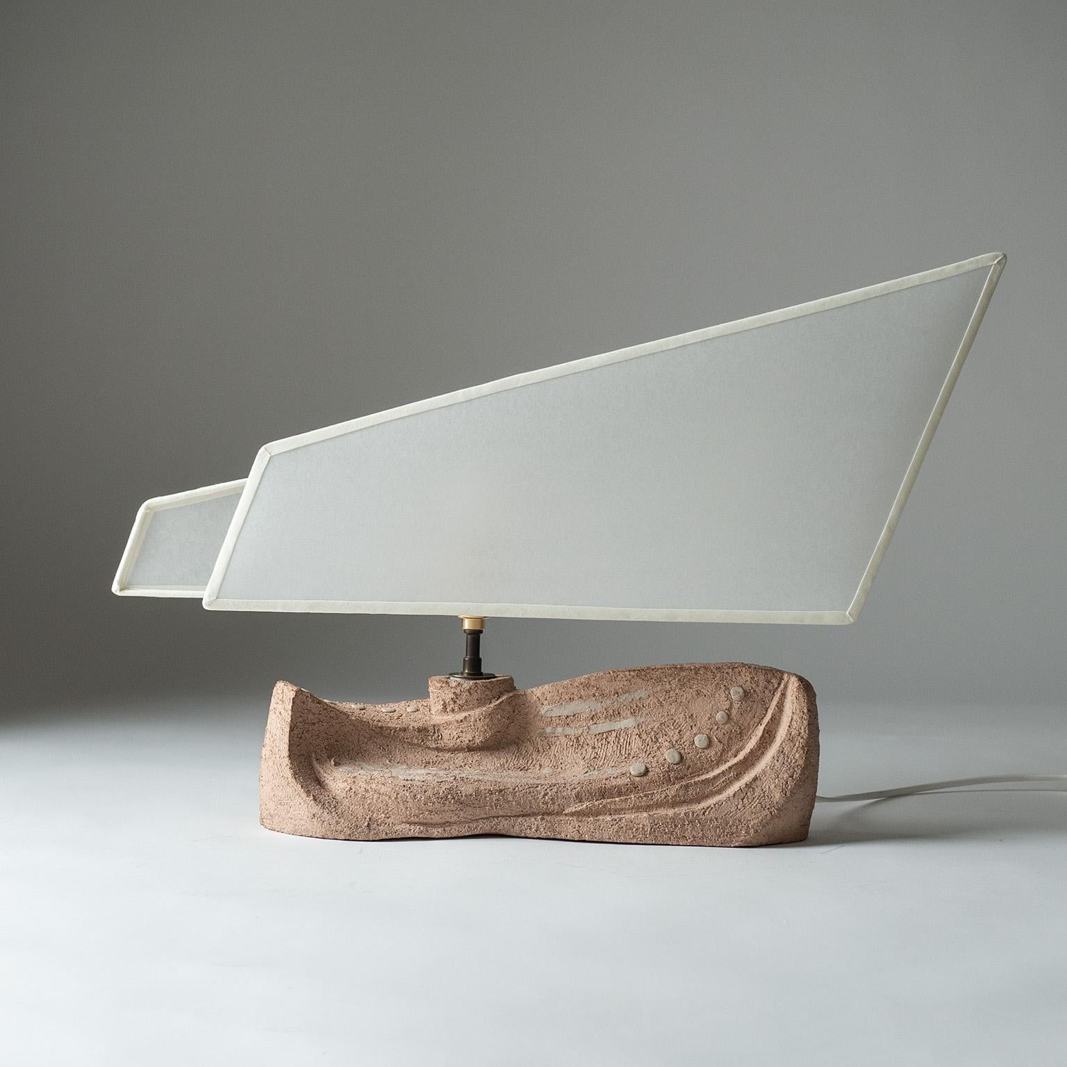 French ceramic table lamp from the 1970s. The abstracted boat-like design has a sculpted chamotte base with a parchment paper shade in the shape of a sail. One brass E14 socket with new wiring.
Measures: Height 39cm (15″), Width 60cm (23.5″), Depth