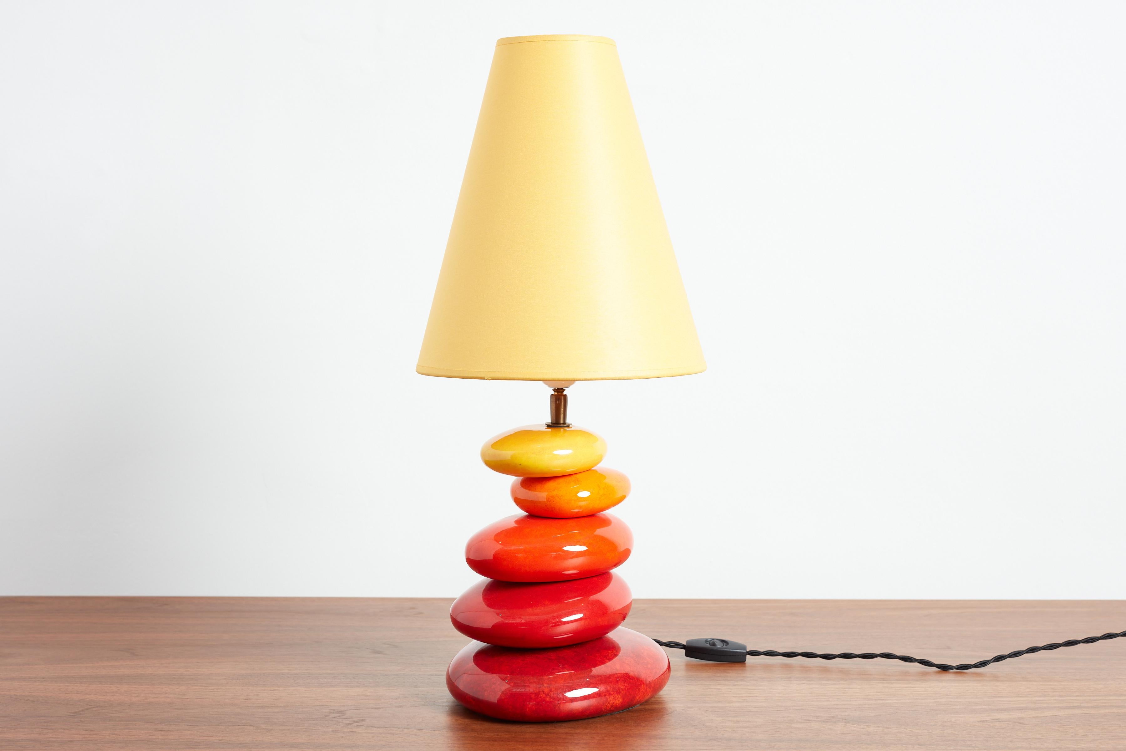 Colorful French ceramic table lamp with irregularly shaped stacked spheres.
France, circa 1970s
Original shade 
Newly rewired
