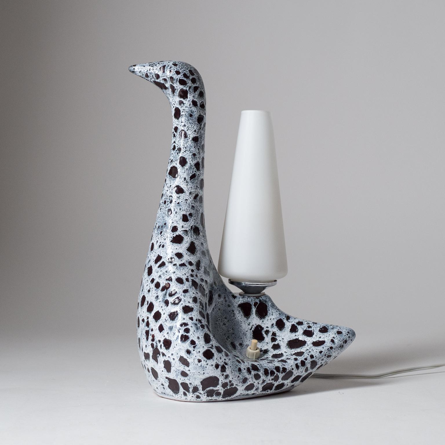 Rare French 'zoomorphe' ceramic table lamp by Le Vaucour, circa 1960. Graceful stylized swan or duck with a fat-lava glazing and a satin glass diffuser. One brass and ceramic E14 socket.
