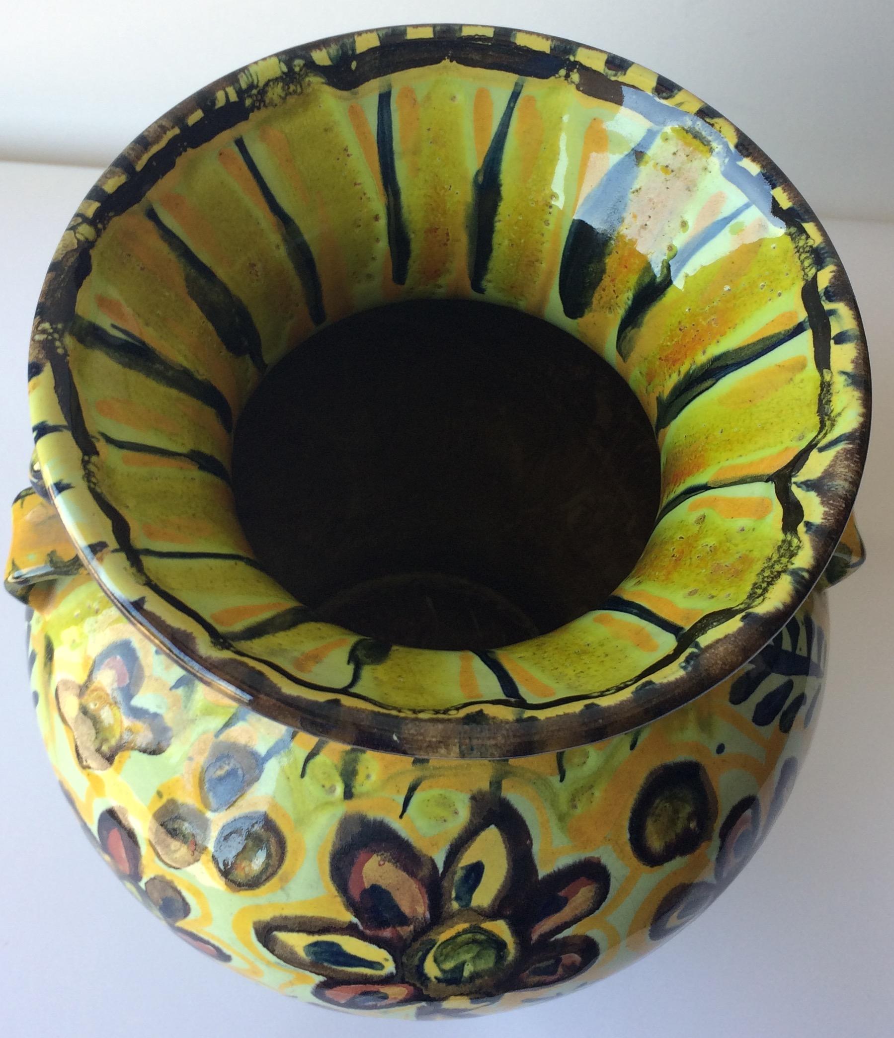Dazzling glazed ceramic vase, the primary pale yellow and the floral designs are truly eye catching. Made in Quimper, France by Keraluc Pottery Studio. 

It can enhance any shelf, table, credenza or countertop as it is truly an interesting