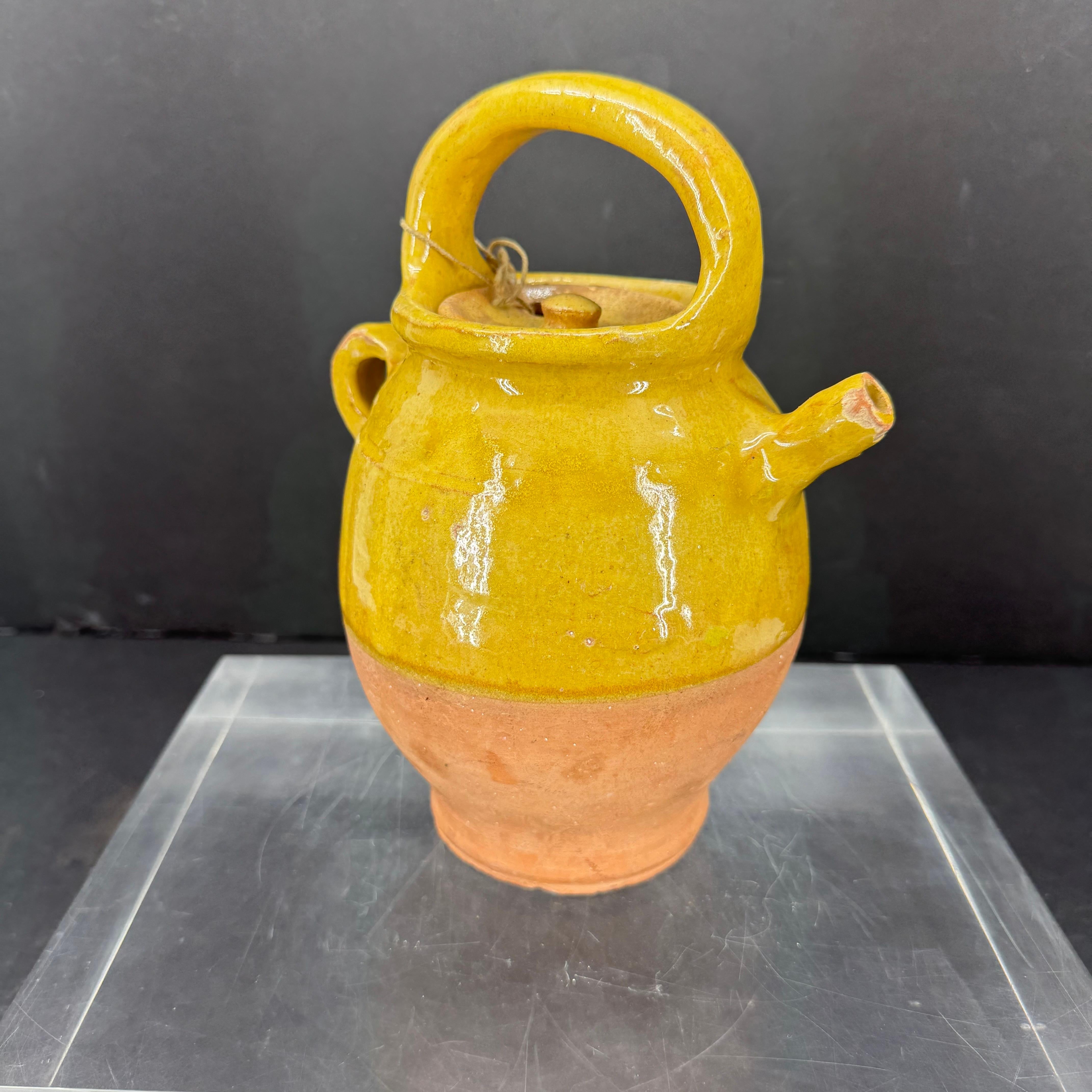 Charming small authentic piece of pottery from Provence. Beautifully weathered jug with an amazing yellow glazed color. Imperfections help authenticate this water cruche from France.