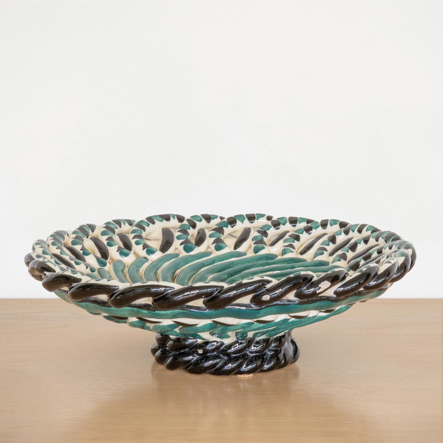 Stunning vintage ceramic bowl with woven loop detail from Vallauris, France. Beautiful spiral detail with green, black, and cream glaze. Unique piece perfect as a decorative object or catch-all.