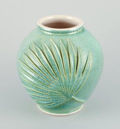 French ceramicist. Large vase in green-blue glaze with palm leaves relief