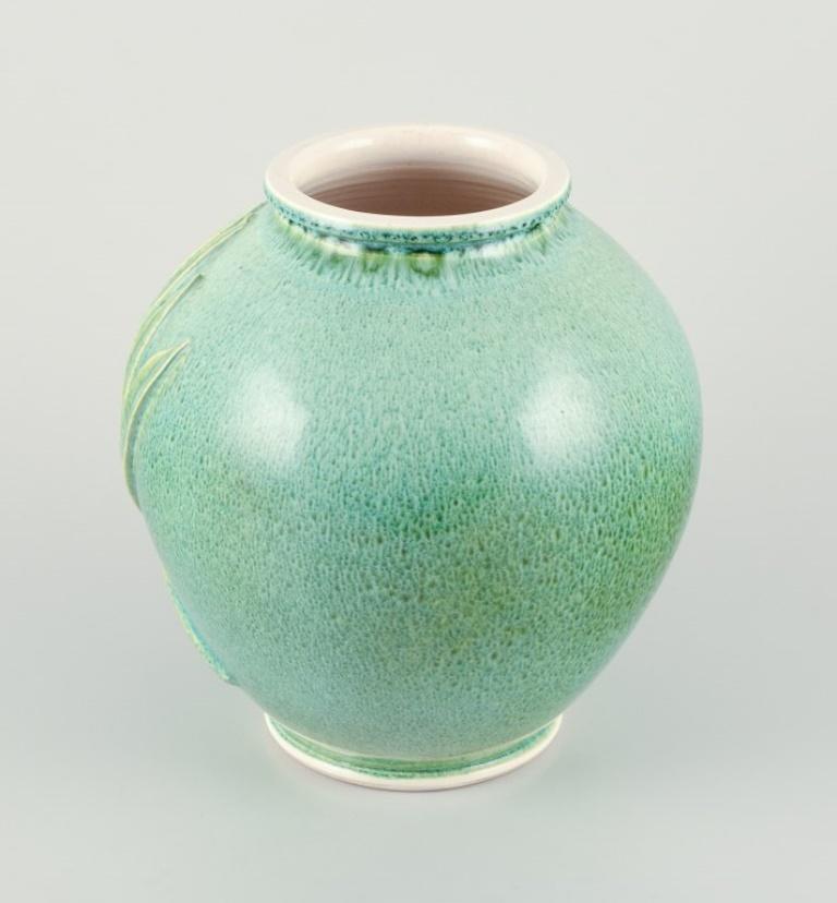 Glazed French ceramicist. Large vase in green-blue glaze with palm leaves relief For Sale