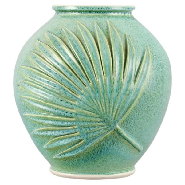 French ceramicist. Large vase in green-blue glaze with palm leaves relief For Sale
