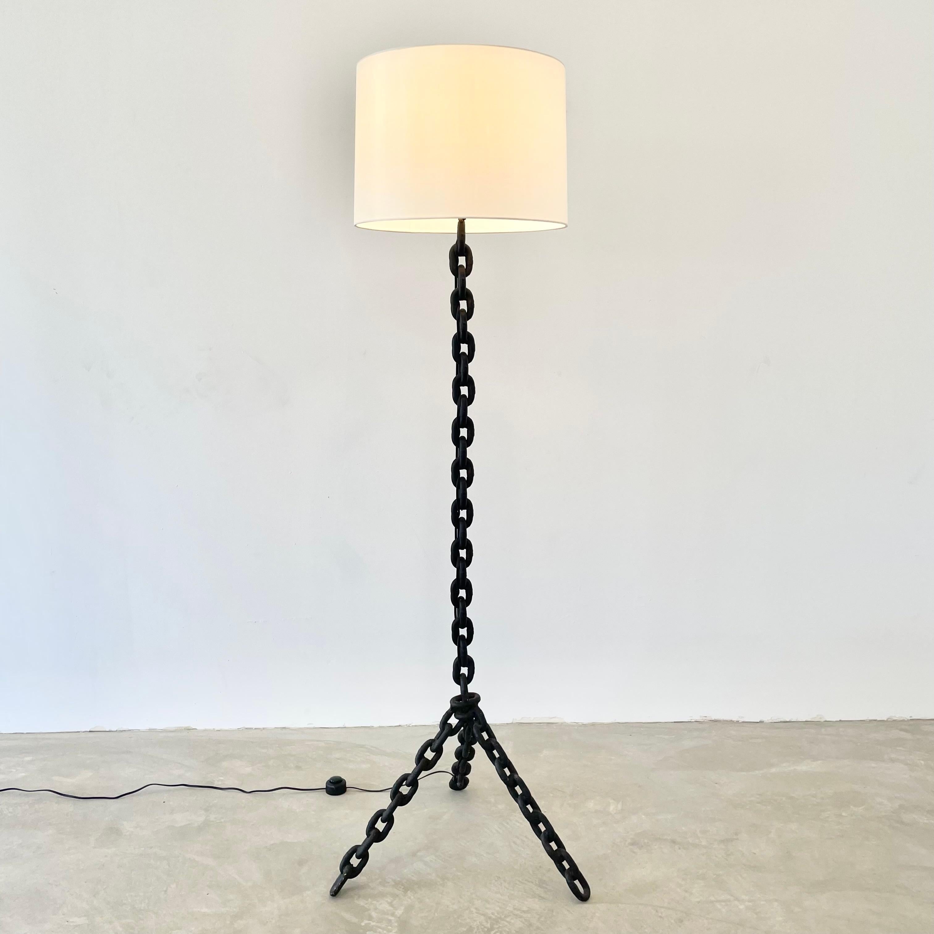Brutalist iron chain link floor lamp, made in 1960s France. Just over 5 feet tall. Extremely heavy and substantial lamp. Tripod base with rustic iron boat chain welded together and painted in a matte black. Features a new custom silk shade with