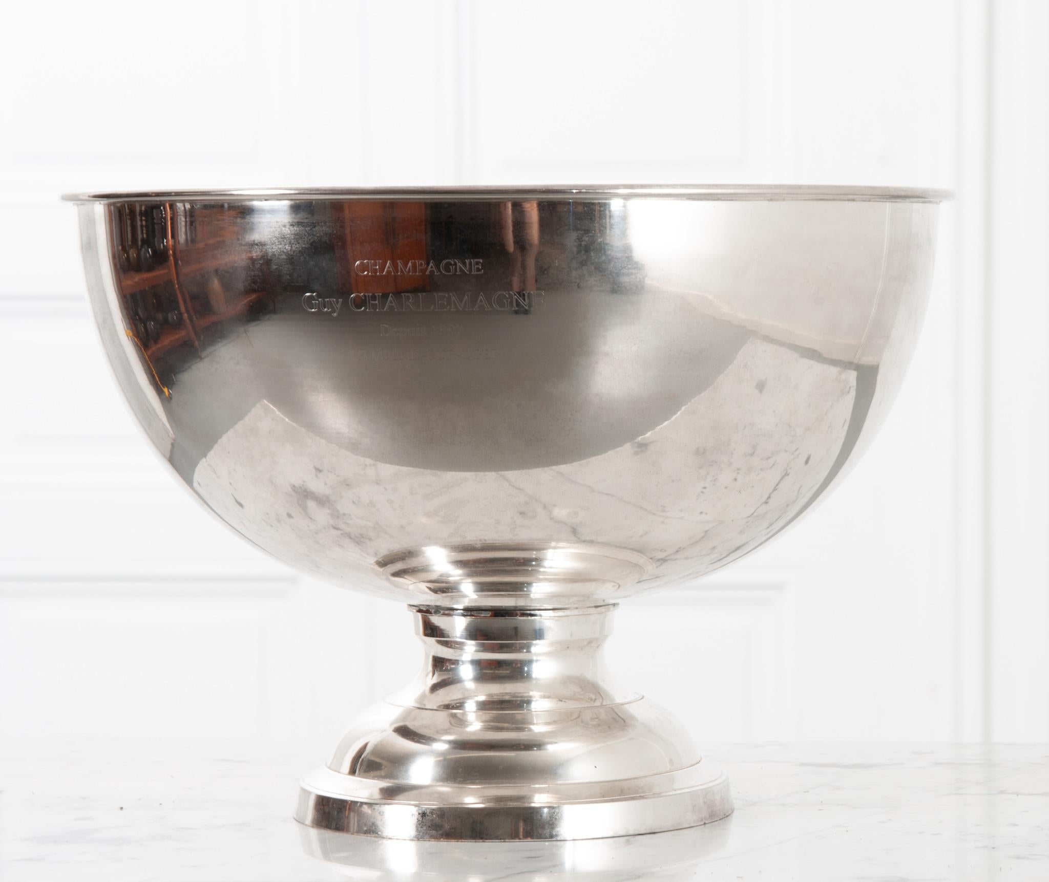 Originally made and distributed by Guy Charlemagne Champagne in the Le Mesnil- Sur- Oger region of north-eastern France, this champagne bucket is silver plated and polished to shine like new. Engraved with “Guy Charlemagne Depuis 1892 Le Mesnil-