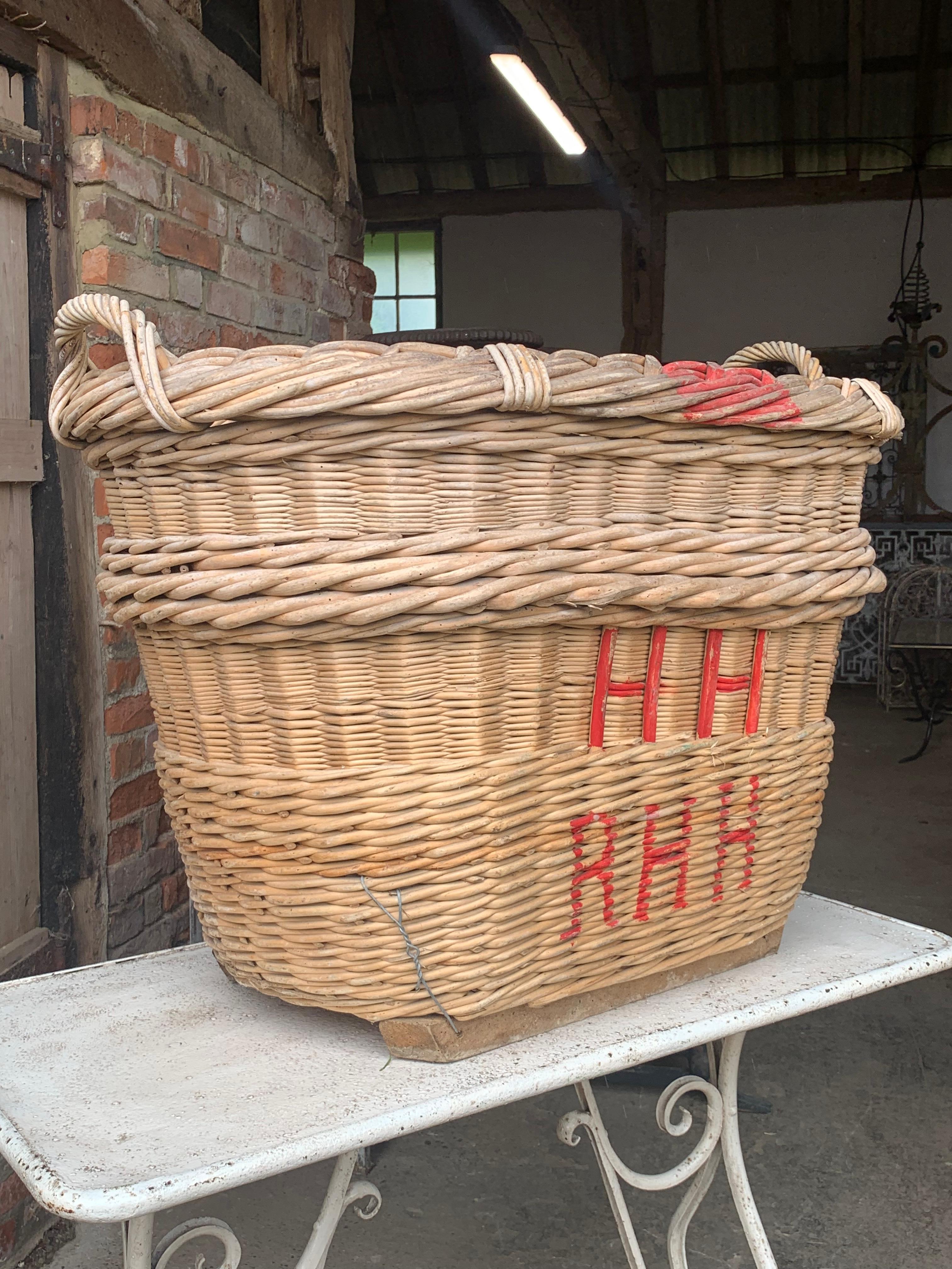 A nice large early 20th century French Champagne grape harvesting basket with the painted markings of the vineyard owner. These were used to harvest the grapes in the vineyards but now make nice decorative and useful baskets.

In good solid