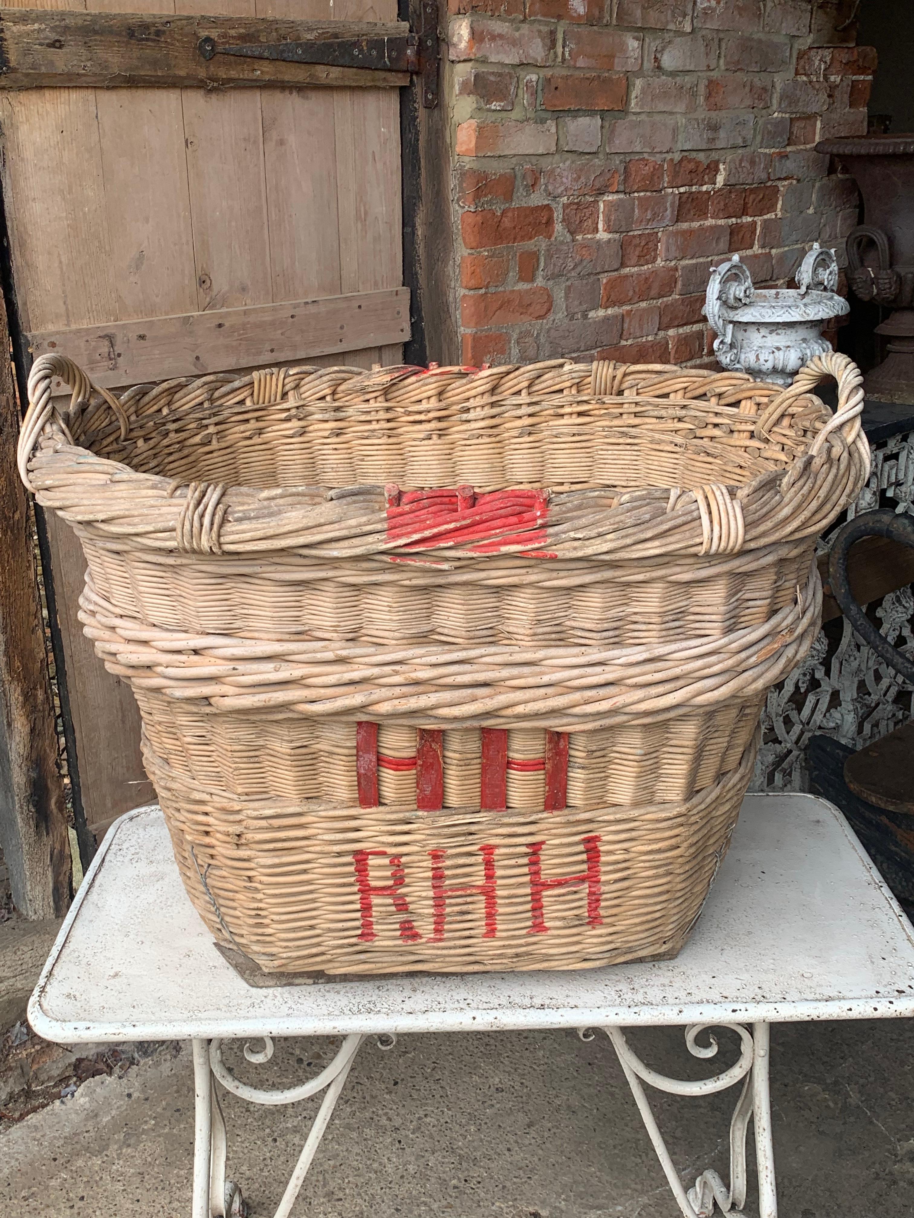 A nice large early 20th century French Champagne grape harvesting basket with the painted markings of the vineyard owner. These were used to harvest the grapes in the vineyards but now make nice decorative and useful baskets.

In good solid