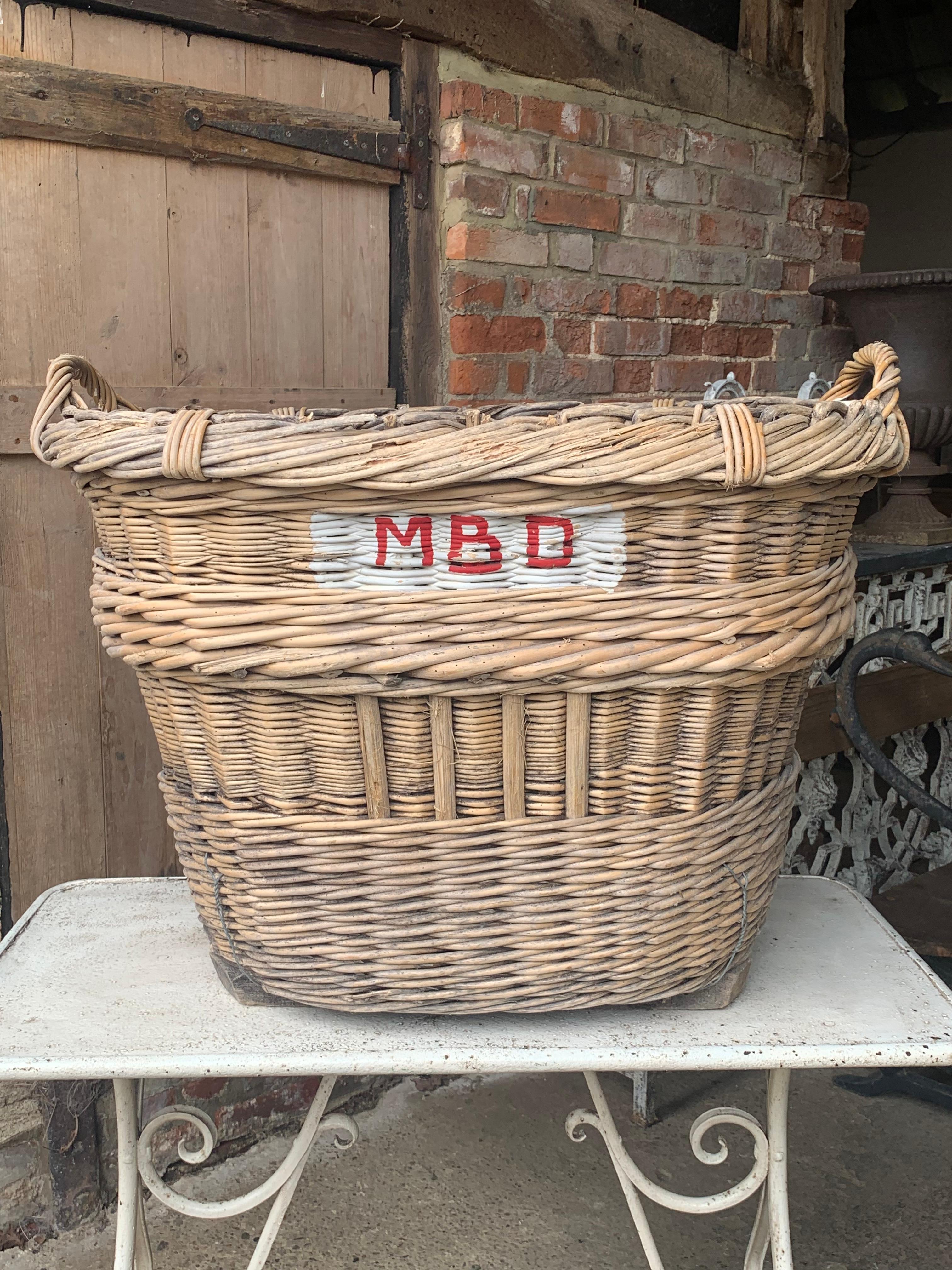 A nice large early 20th century French Champagne grape harvesting basket with the painted markings of the vineyard owner. These were used to harvest the grapes in the vineyards but now make nice decorative and useful baskets.

In good solid