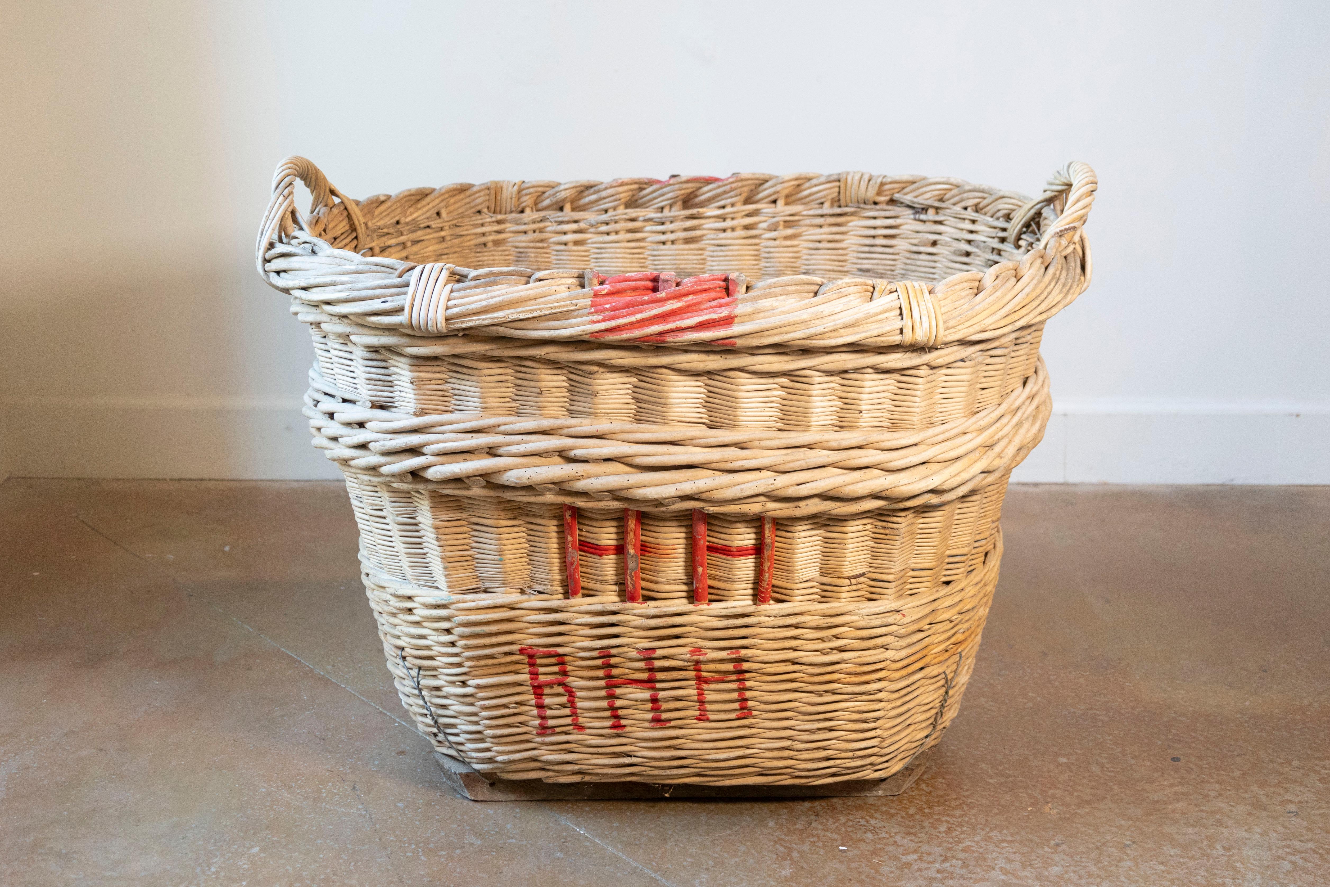 A rare and beautifully preserved French Champagne harvesting basket dating to the 1940s, hailing from the legendary vineyards of the Champagne region. This hand-woven willow basket was once a vital tool during the grape harvest, carried through the