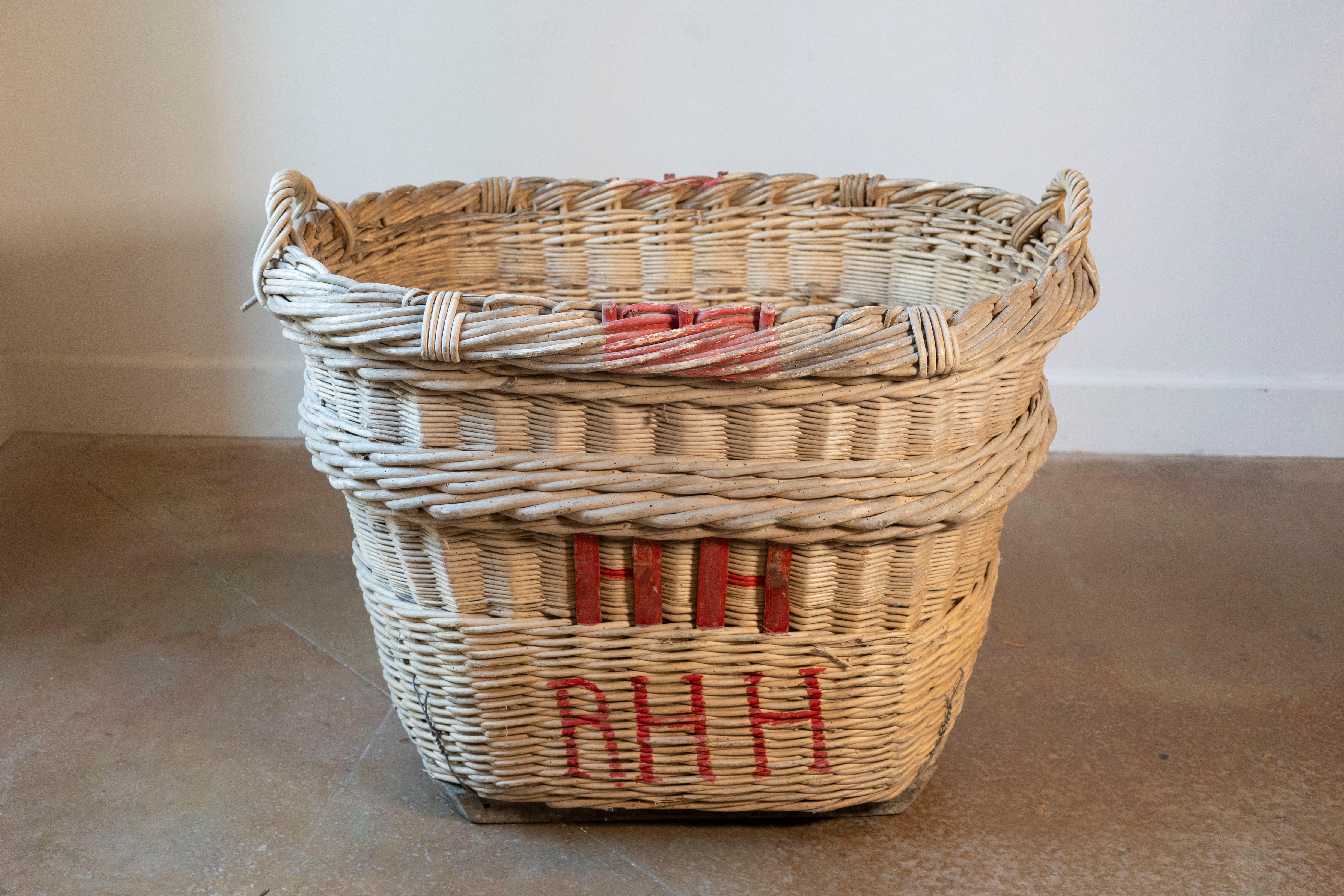 A rare and beautifully preserved French Champagne harvesting basket dating to the 1940s, hailing from the legendary vineyards of the Champagne region. This hand-woven willow basket was once a vital tool during the grape harvest, carried through the