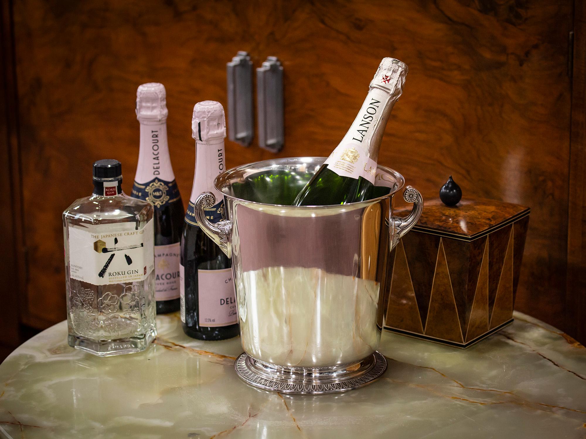 With Twin Looping Handles

From our Barware collection, we are pleased to offer this Silver-Plated French Champagne Wine Cooler Bucket. The bucket with flared top rim, twin scroll handles, pinched base and a splayed foot. Decorated with fine quality