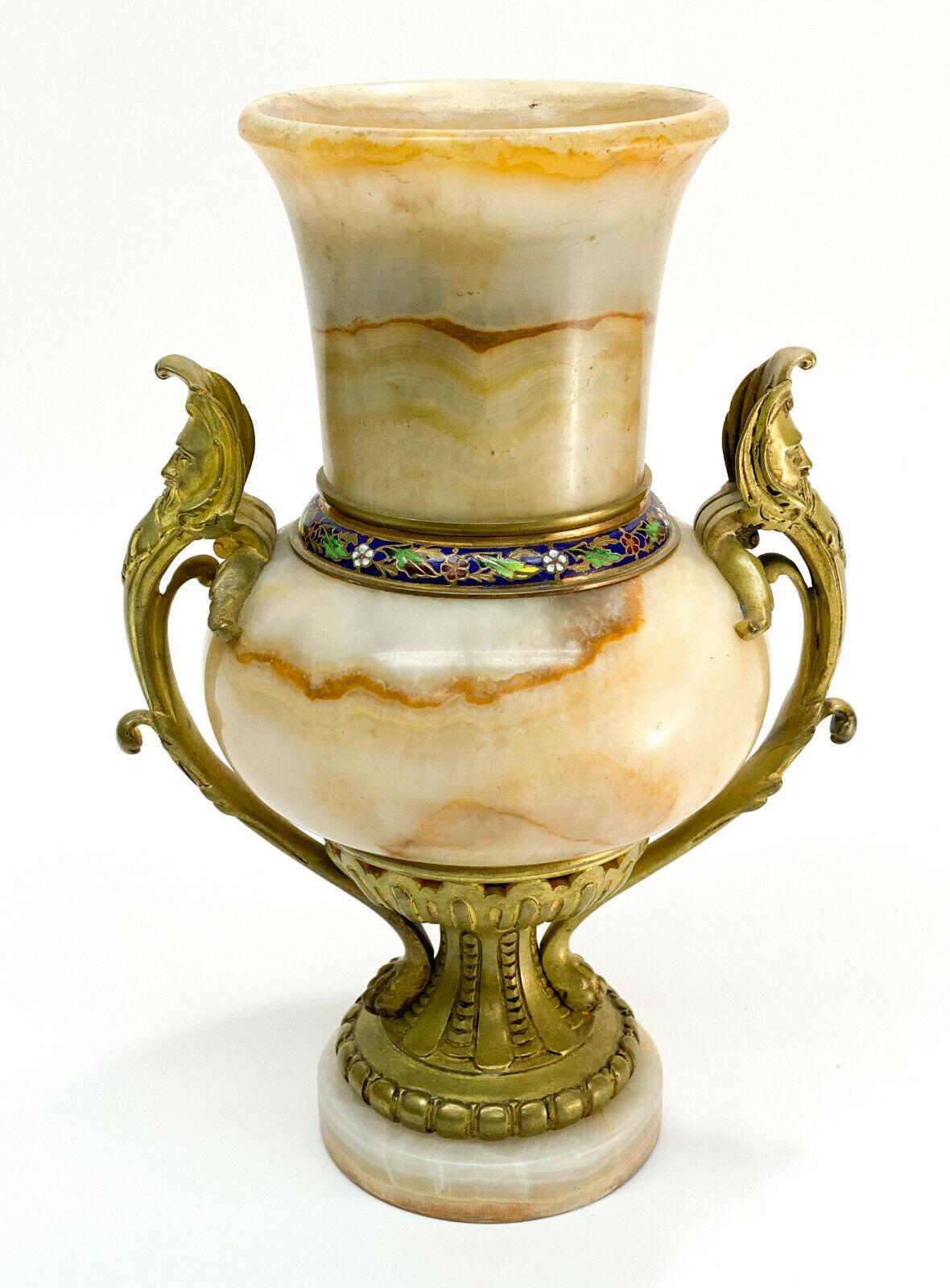 French Champleve Enamel and Beige onyx stone bronze Mounted Urn, 19th century

Blue and floral champleve enamel to the circular band connecting the neck to the body. Gilt bronze mounts to the figural twin handles and stem.

Additional