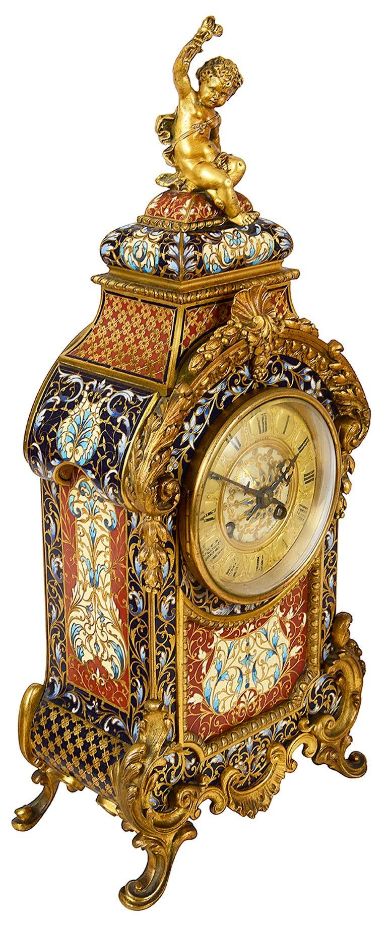 A very good quality late 19th Century French gilded ormolu and champleve enamel clock set. The matching three brach candelabra with scrolling foliate rococo style decoration and bold colouring enamel.
The clock having a putti seated above holding a