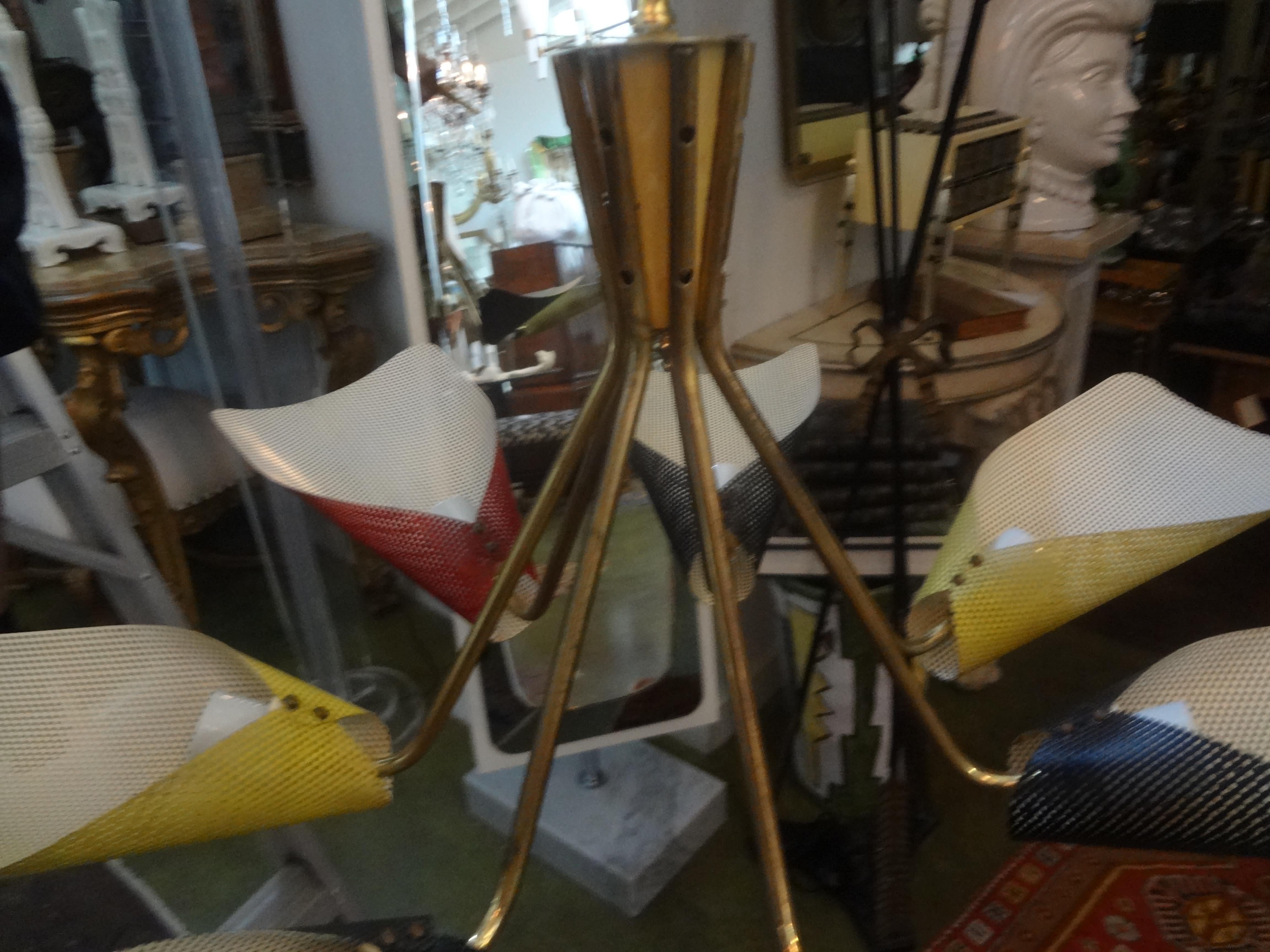 French Chandelier Attributed to Mathieu Matégot

This stunning French mid century modern chandelier has 7 perforated polychromed metal shades in black, red and yellow and has been newly wired with new sockets for the U.S. market.
Our French
