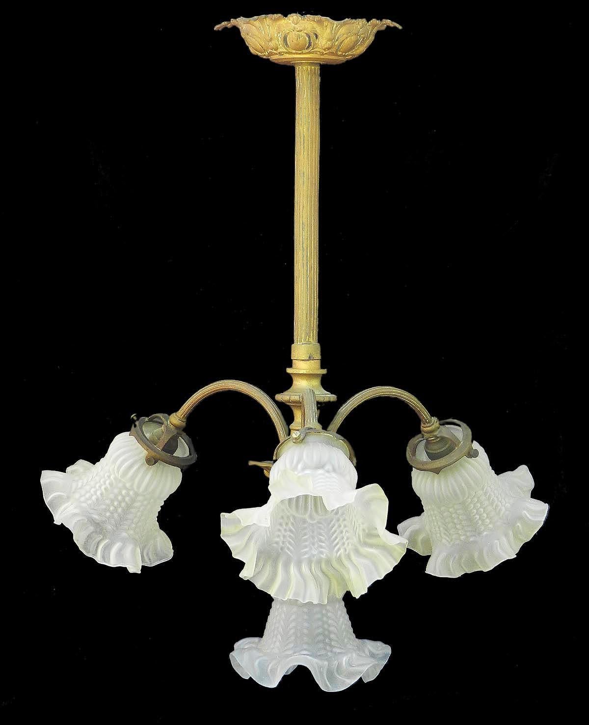 French chandelier, circa 1900, Belle Époque
Four branch
Ornate gilt bronze light, three stems with glass frilled tulip shades surrounding a central tulip shade
In good original condition with no losses to the glass 
Good age patina to the