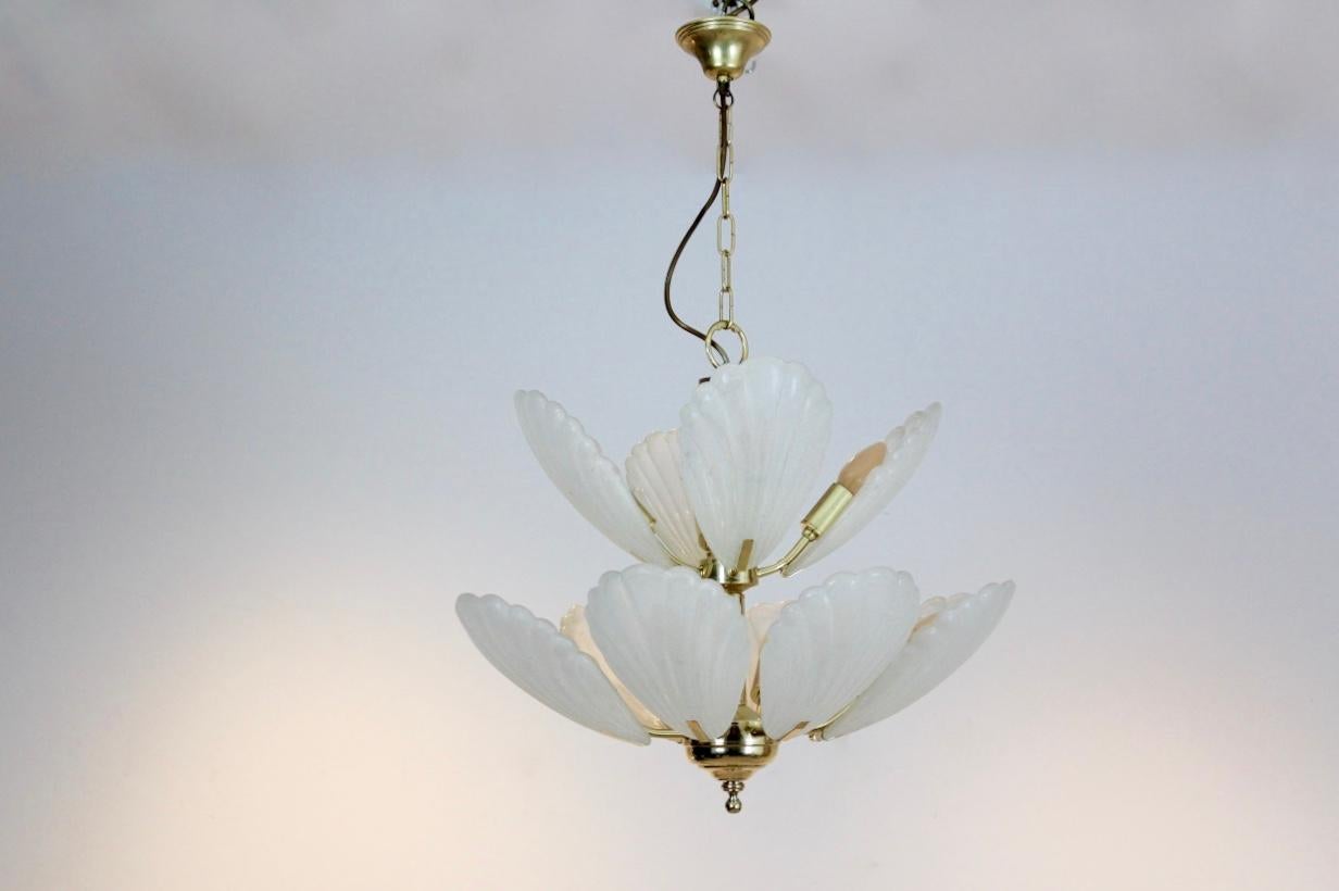 Wonderful chandelier made in France with 12 beautiful characteristic Murano frosted glass shells on a brass base. Manufactured in the early 1970s. Very impressive large glass chandelier and beautiful light effect when lit. In excellent condition.