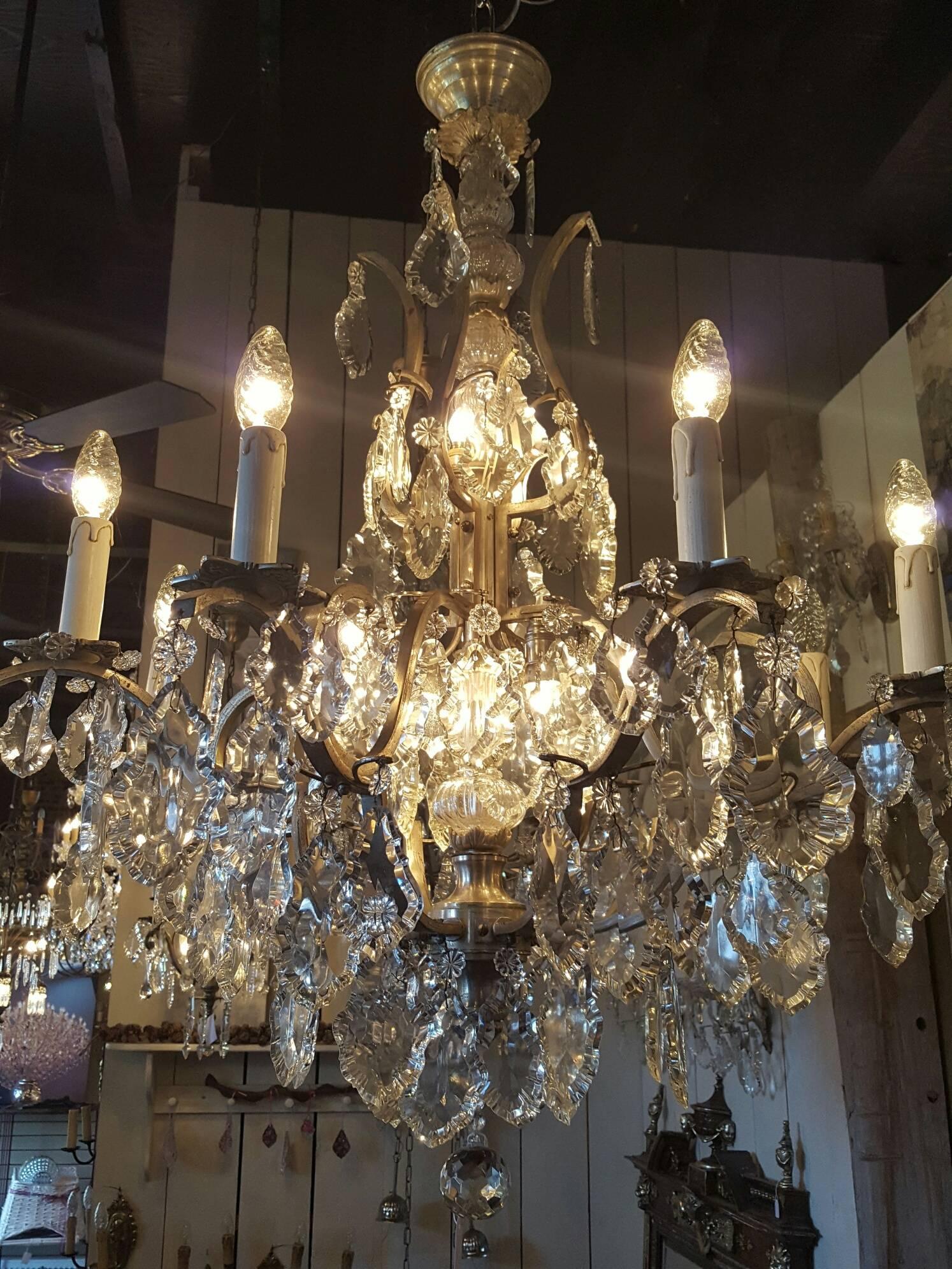 Very nice French chandelier with frame of silver plated copper with eight candle lights and four lights in the center of the chandelier. Original piece early 1900.

This is just one of our large collection chandeliers. Besides the old and antique