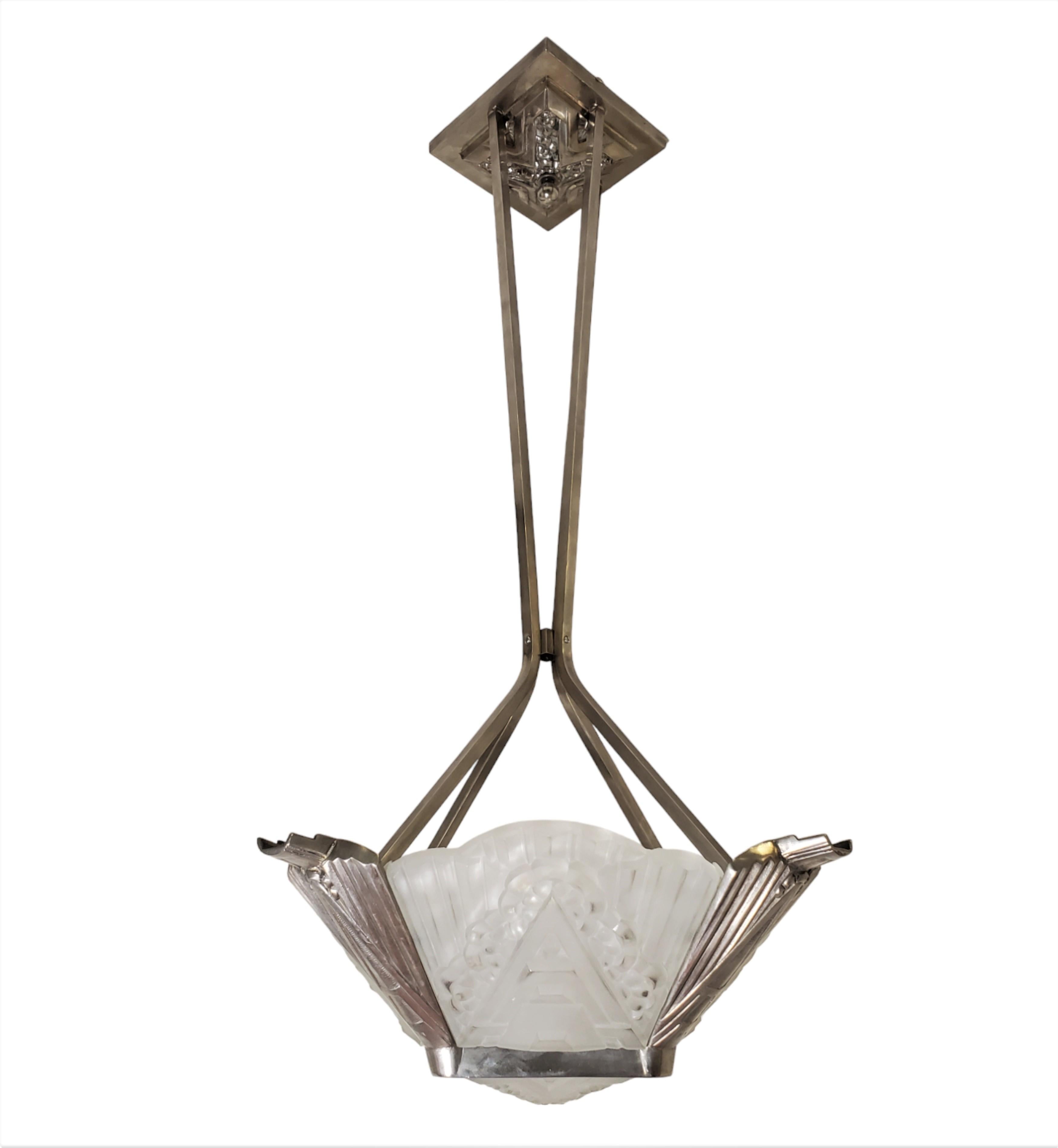 An original French Art Deco molded art glass chandelier comprising four panels plus a square center. The panels are created using a frosted process with polished areas producing glossy highlights giving the glass extra depth and presence.
 Each