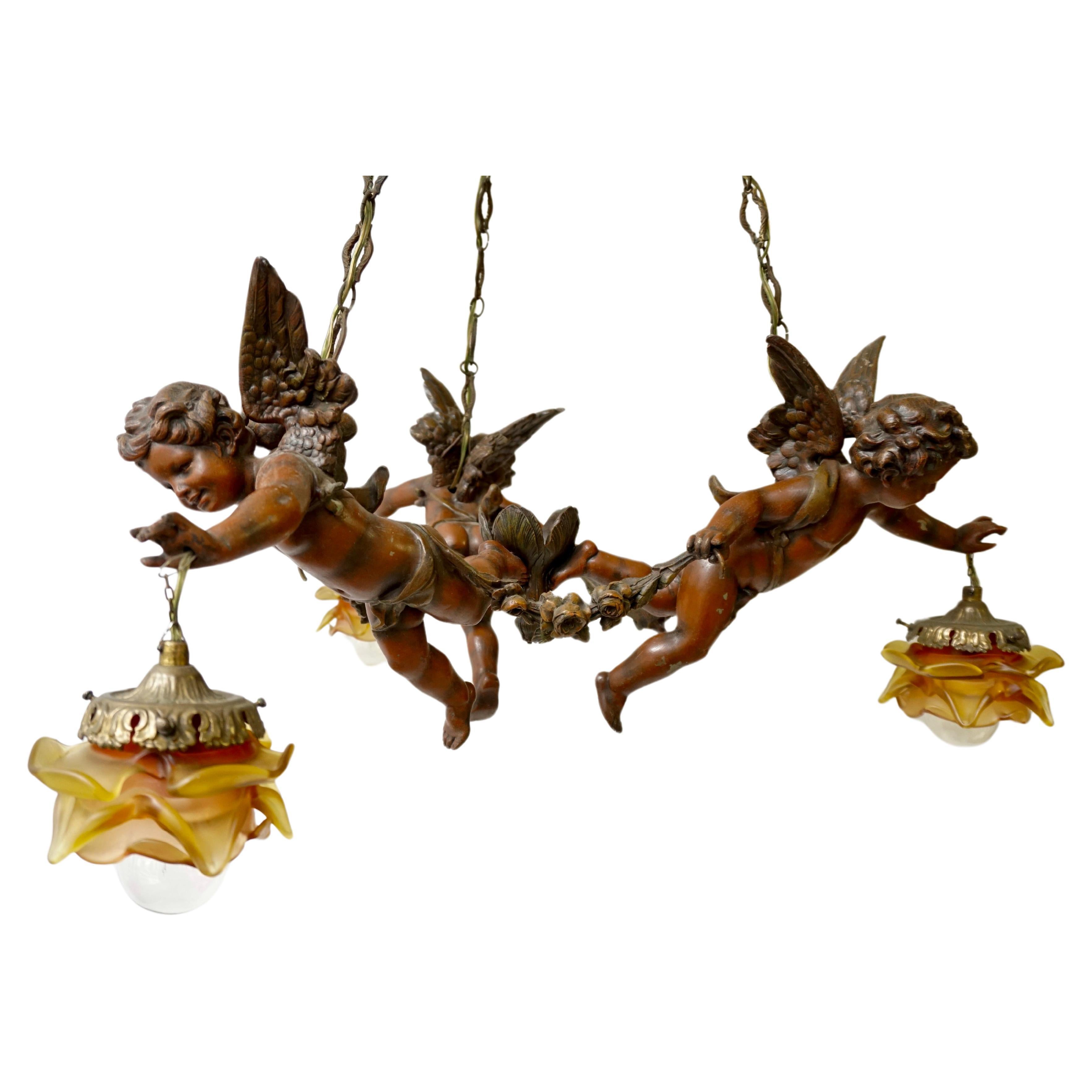 French Chandelier with Three Cherubs Holding the Lights For Sale