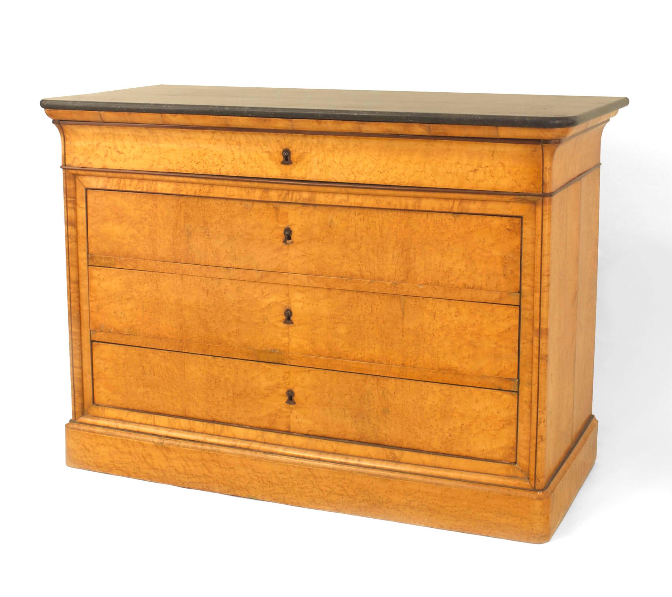 French Charles X (1830s) birds eye maple and mahogany trimmed chest with 4 drawers resting under a black marble top.
