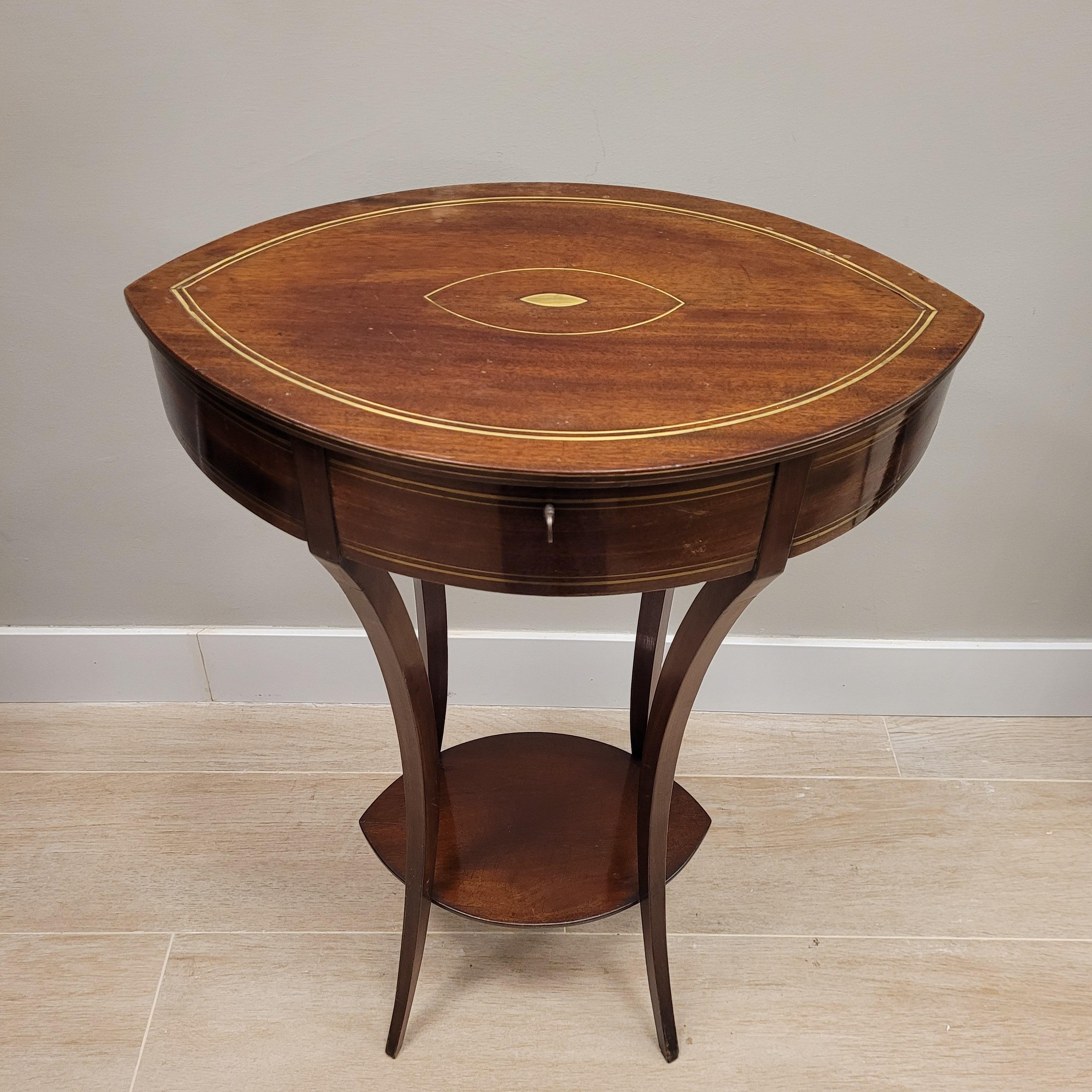 Gorgeous and very refined  and elegant Charles X sewing box and leaf shaped table , around 1830  France. This small side table is made of mahogany wood and gold brass threaded inlays. It is structured in a simple and light way, the main body has an