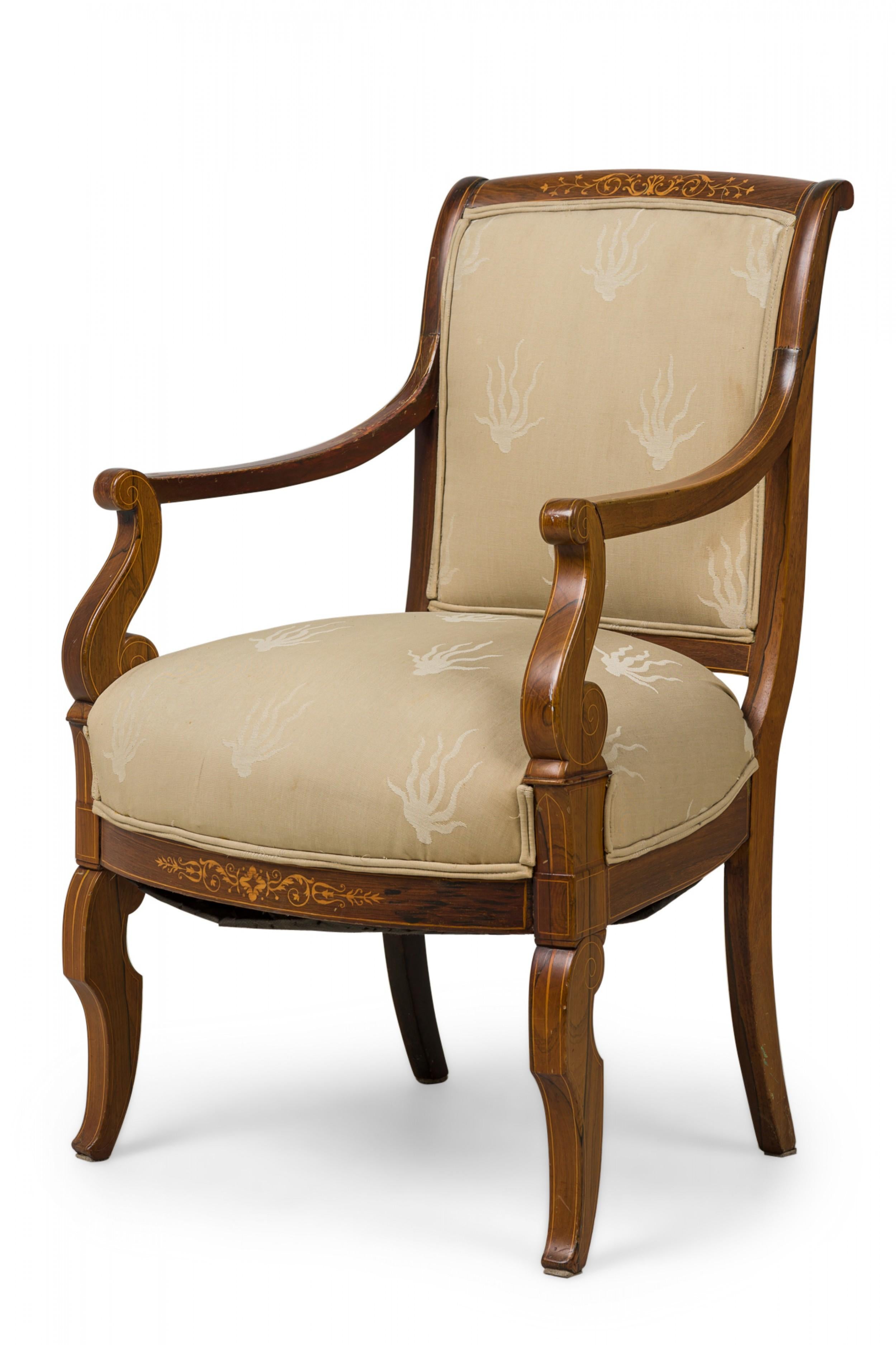 French Charles X (19th Century) open armchair featuring a scroll form mahogany frame with sweeping arms, inlaid walnut parquetry on the backrest and front friezes, upholstered in a two-toned beige patterned fabric with double piping, standing on