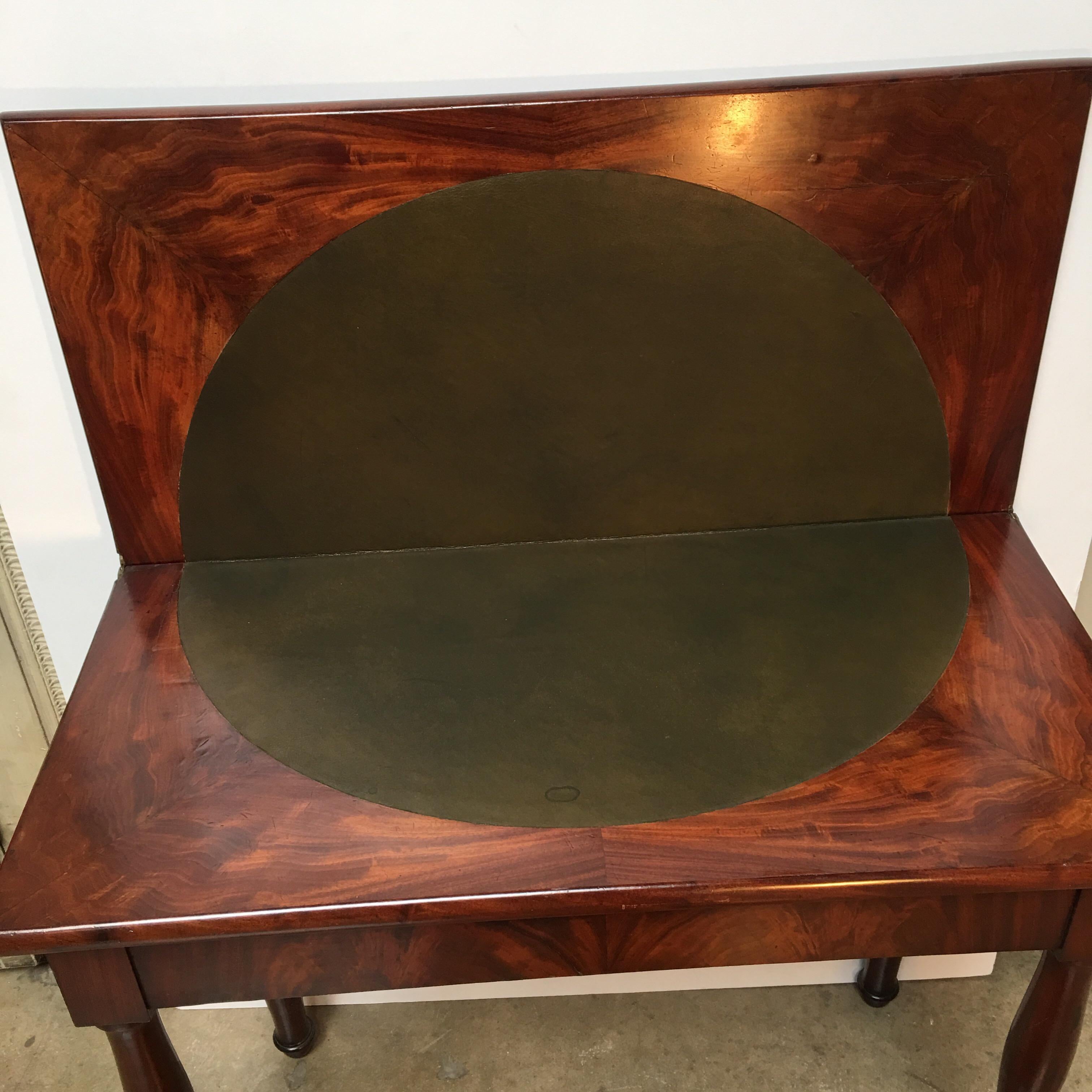 A French Charles X mahogany flip top game table with leather.