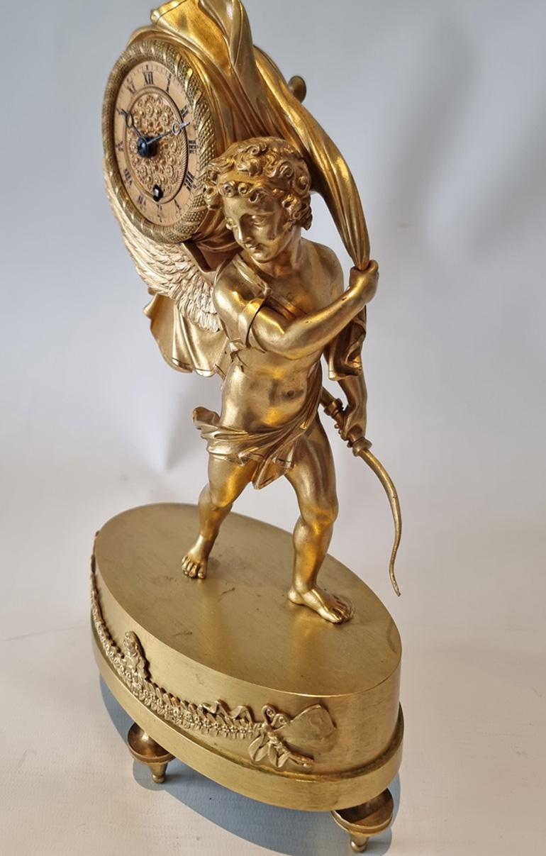 Fabulous antique French Charles X miniature mantel clock of Cupid carrying off time. This has to be one of my all time favourite French Empire or Charles X period mantel clocks. Entirely original fire gilded mercury ormolu, on the model which is