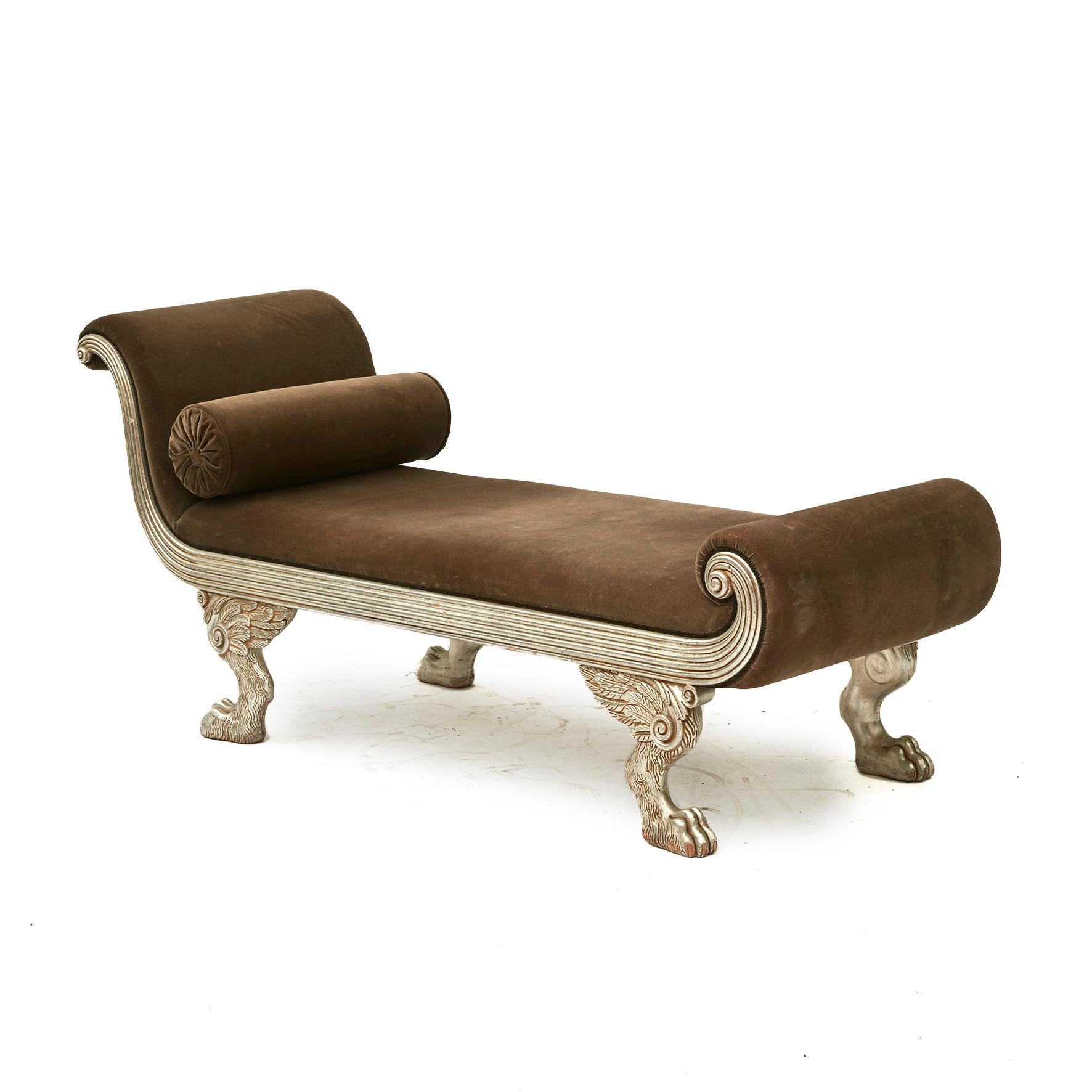 French 20th century recamier or daybed in the style of Charles X.
This elegant recamier is featuring graceful curves in the form of fluted scrolled ends and a silver giltwood finish.
Resting on four winged lions paw feet. Upholstered in brown