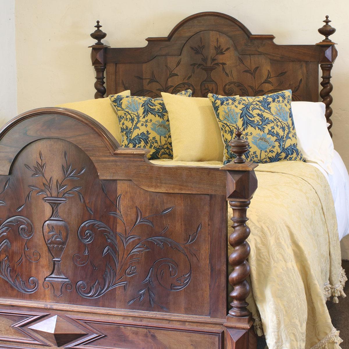 An attractive carved walnut bed with barley twist posts and decorative panels.

This bed accepts a British King size or American Queen size, 5ft wide (60 inches or 150cm) base and mattress set.

The price includes a standard firm bed base to