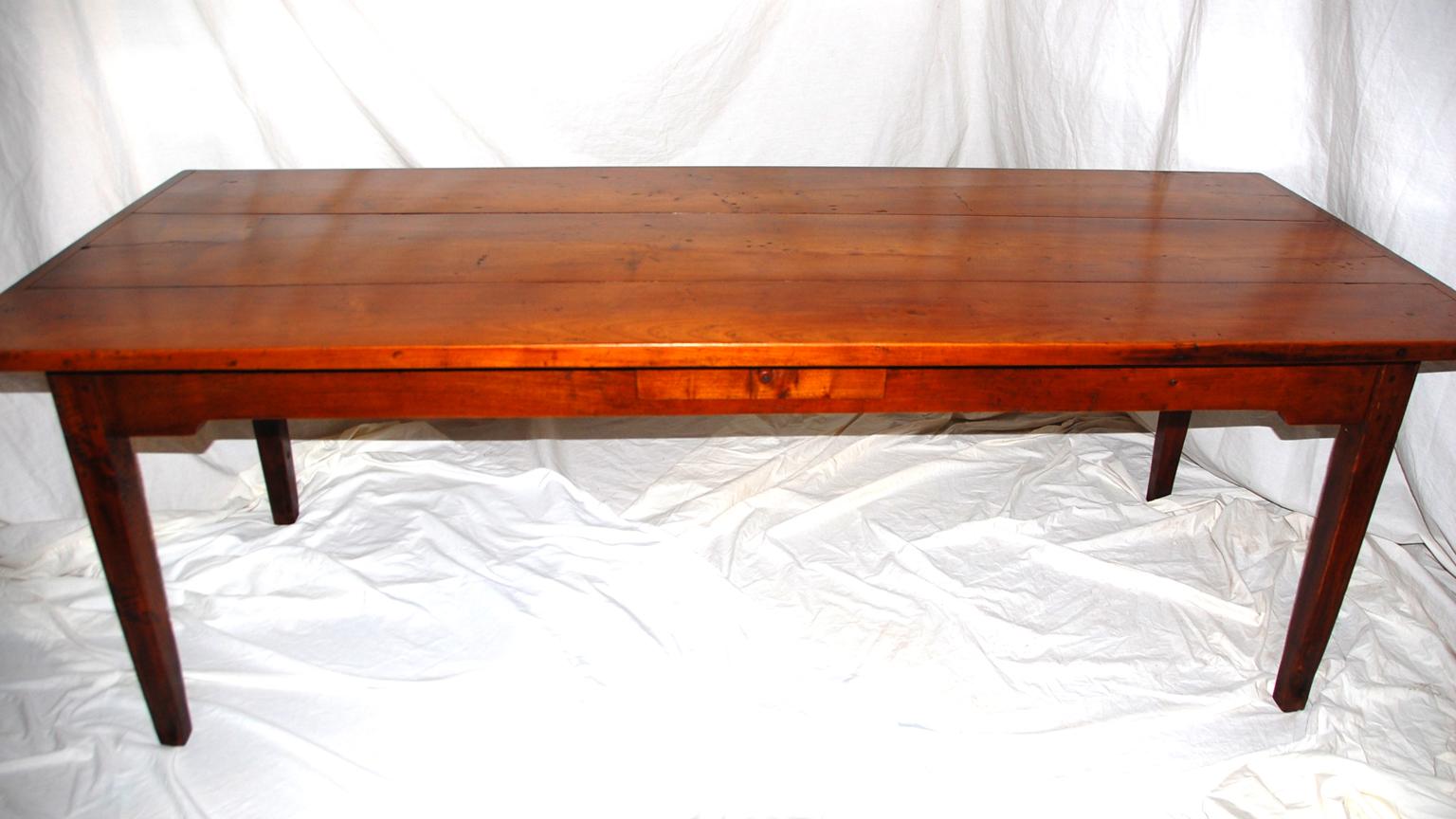 French cherry long farm house table, 89 inches in length with a thick three plank cherry top, cherry squared tapered and molded legs, breadboard ends, peg and tenoned construction. This Normandy classic that has been restored and is ready for use.