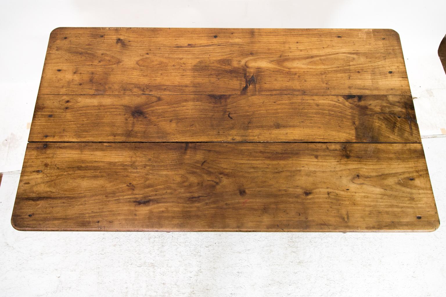 This French cherry table has been reduced to coffee table height at a later date. The right-hand drawer is functional, and the one left hand apparent drawer is actually a fold down cupboard.