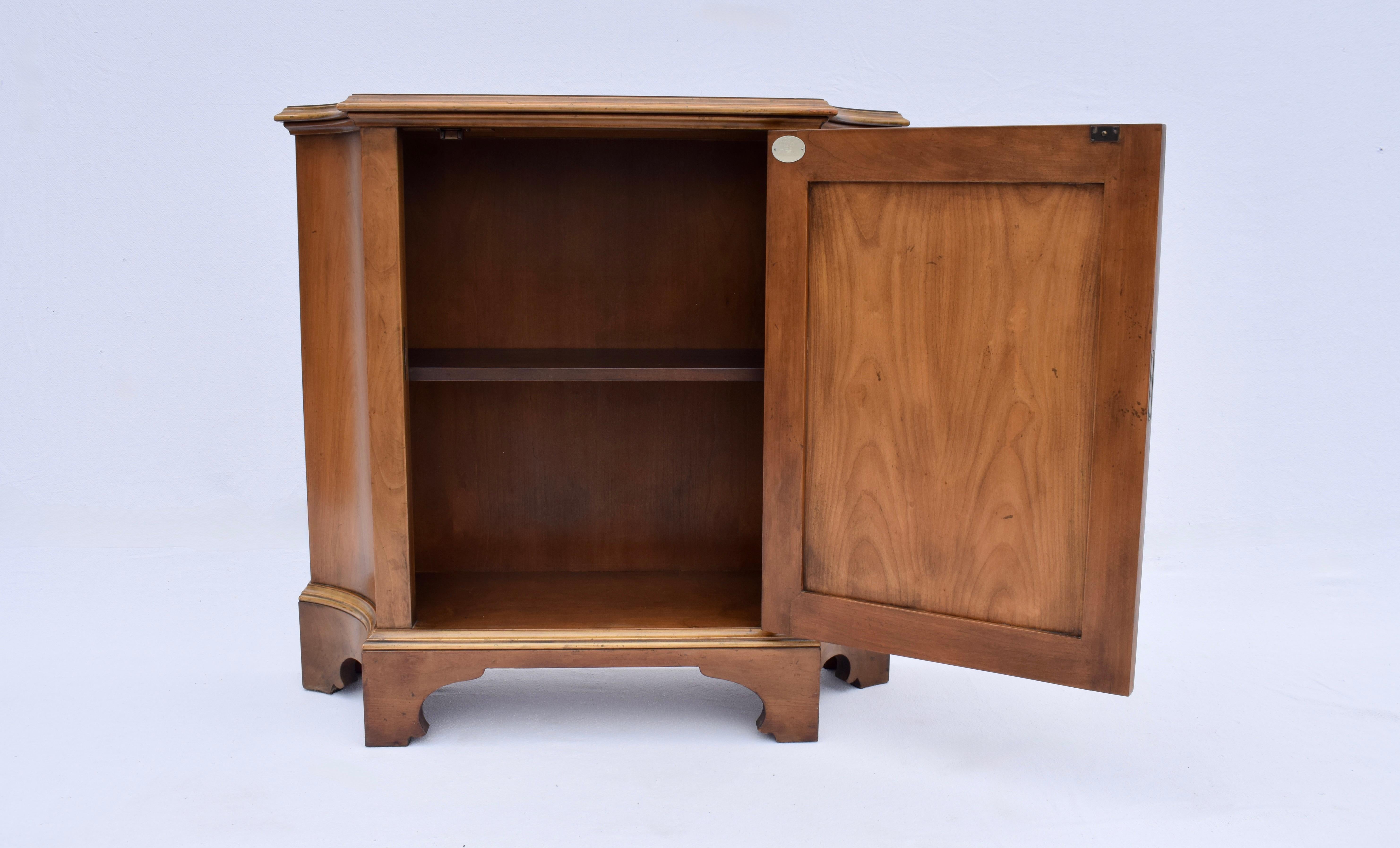 A versatile console cabinet or commode by Baker Furniture, circa 1960s of French cherry wood with a single raised panel door and one shelf. Features working lock & original brass key.  A marvelous multifunctional cabinet.

Style No 5055-3 (Commode