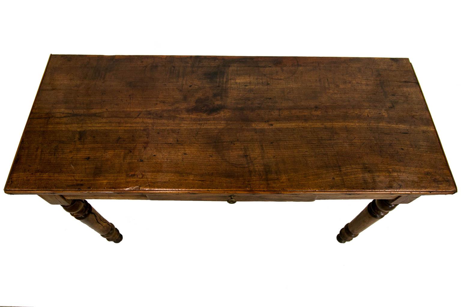 The top of this console table has applied molding on three sides. The top patina has blemishes commensurate with use and age. The drawer bottom and sides have been trimmed at the back.