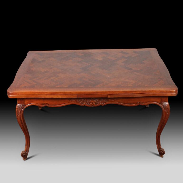 French Provincial style draw leaf parquet dining table, the serpentine walnut parquet top with two pull out leaves above shaped carved apron. All raised up on cabriole legs terminating on scroll feet..  Comes with 2 leaves that extend each end of