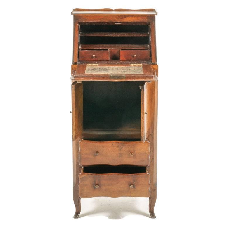 Small and very usable drop-front desk – perfect for a laptop. Made of solid cherry with two-door storage area below the desk and two drawers at the bottom, circa 1900.

Measures: 17? wide x 14? deep (26? with desktop open) x 40? tall.

