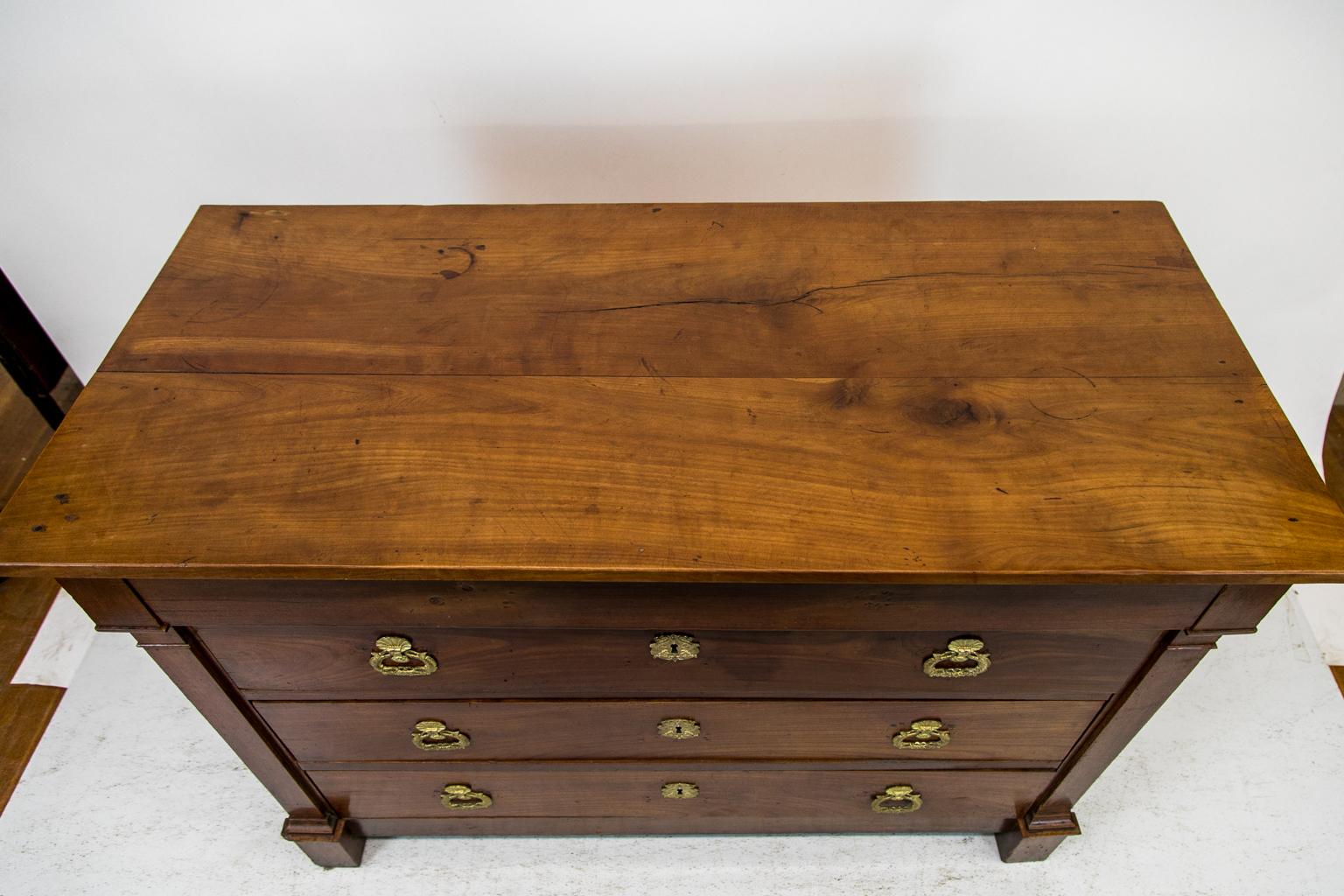 This four-drawer chest or commode is made of French cherry. The top is 23