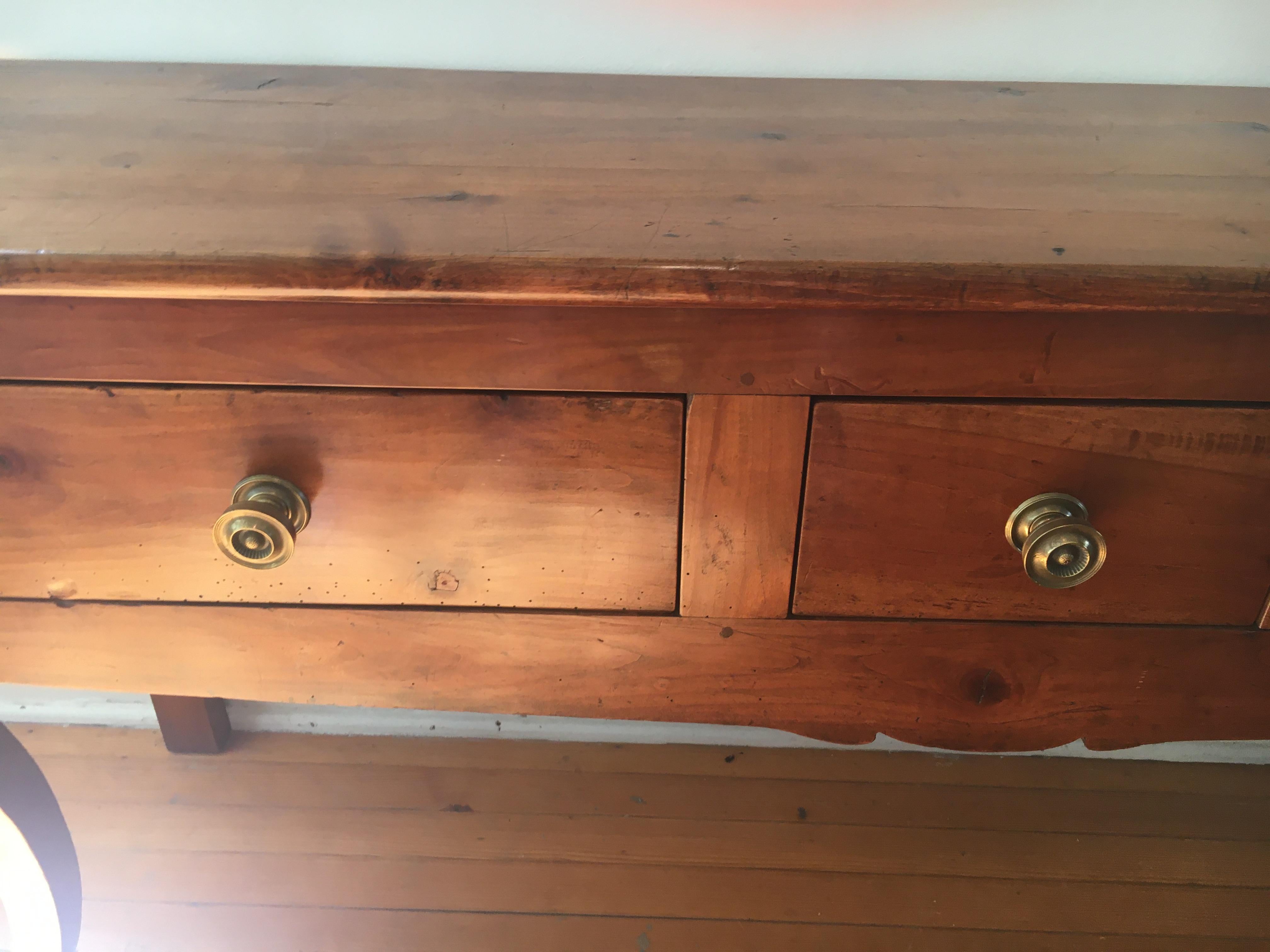 Cherry, circa 1830 - This 3-drawer cherry serving table has the warmest and best patina of anything in our store. The table has cabriole legs and old brass knobs that were not the original knobs but adds a wonderful dimension to this stunning