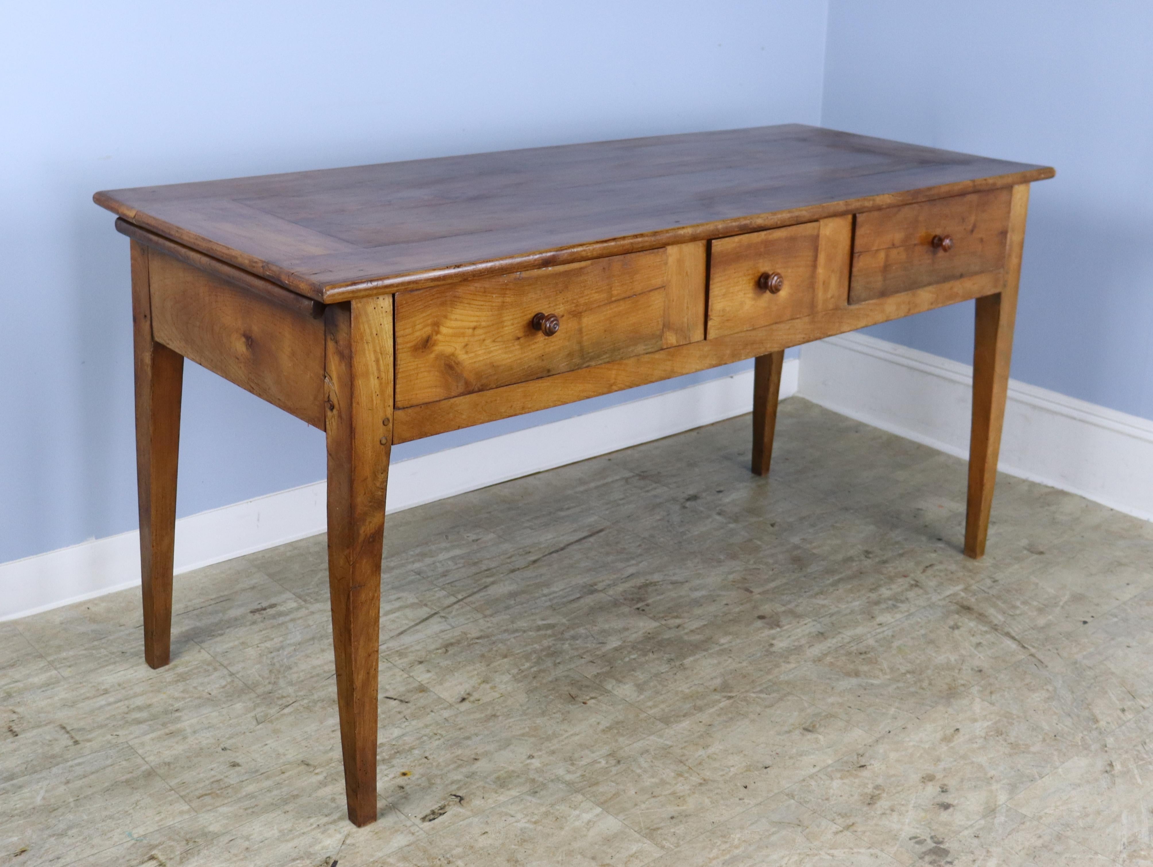 A simple three drawer server or console table in warm cherry. Classic tapered legs. very good color, grain, and patina on the top. Useful depth. Beautiful original breadslide creates another serving surface and looks cool.