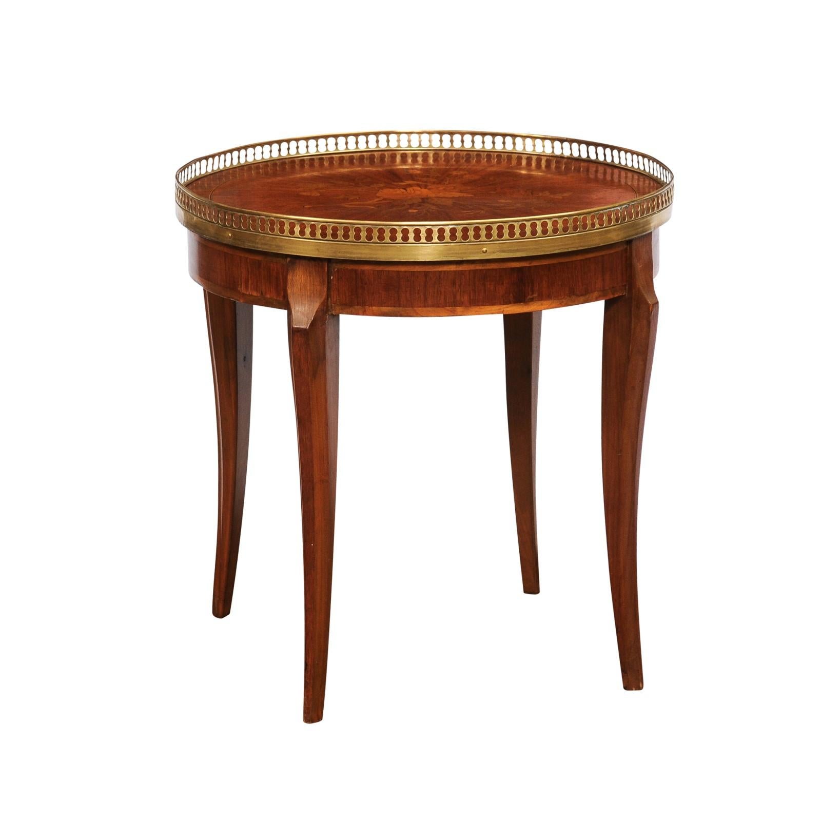 A French walnut, cherry and mahogany bouillotte game table with marquetry top, pierced brass gallery, cross banding and slightly saber legs. Experience the elegance of French craftsmanship with this 20th-century walnut, cherry, and mahogany