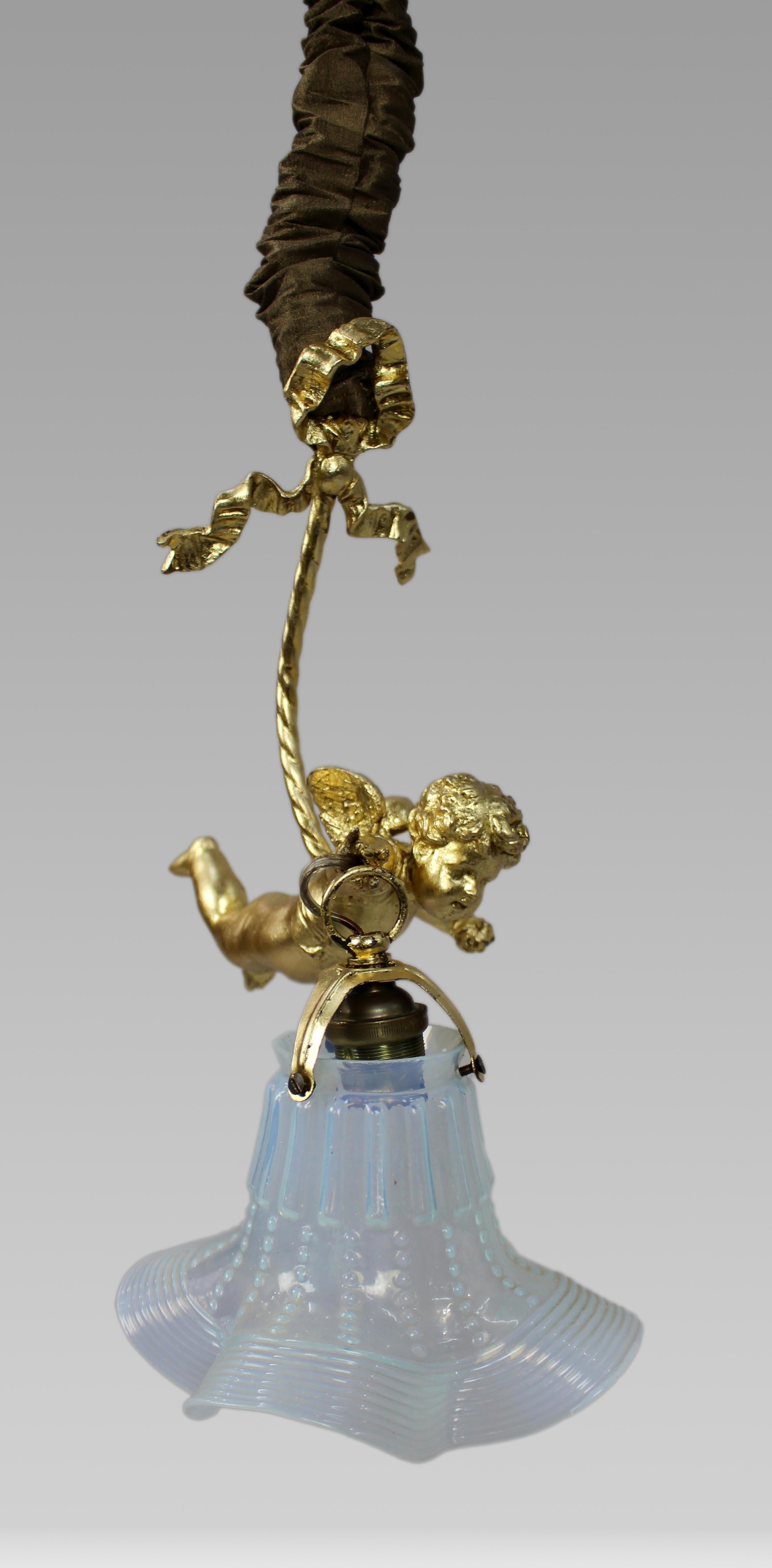 Lámpara colgante francesa Querubín con pantalla de cristal de vaselina, hacia 1900-1920

Descripción:
Encantadora lámpara colgante francesa de principios del siglo XX, hacia 1900-1920, con una figura de querubín de metal fundido suspendida de un