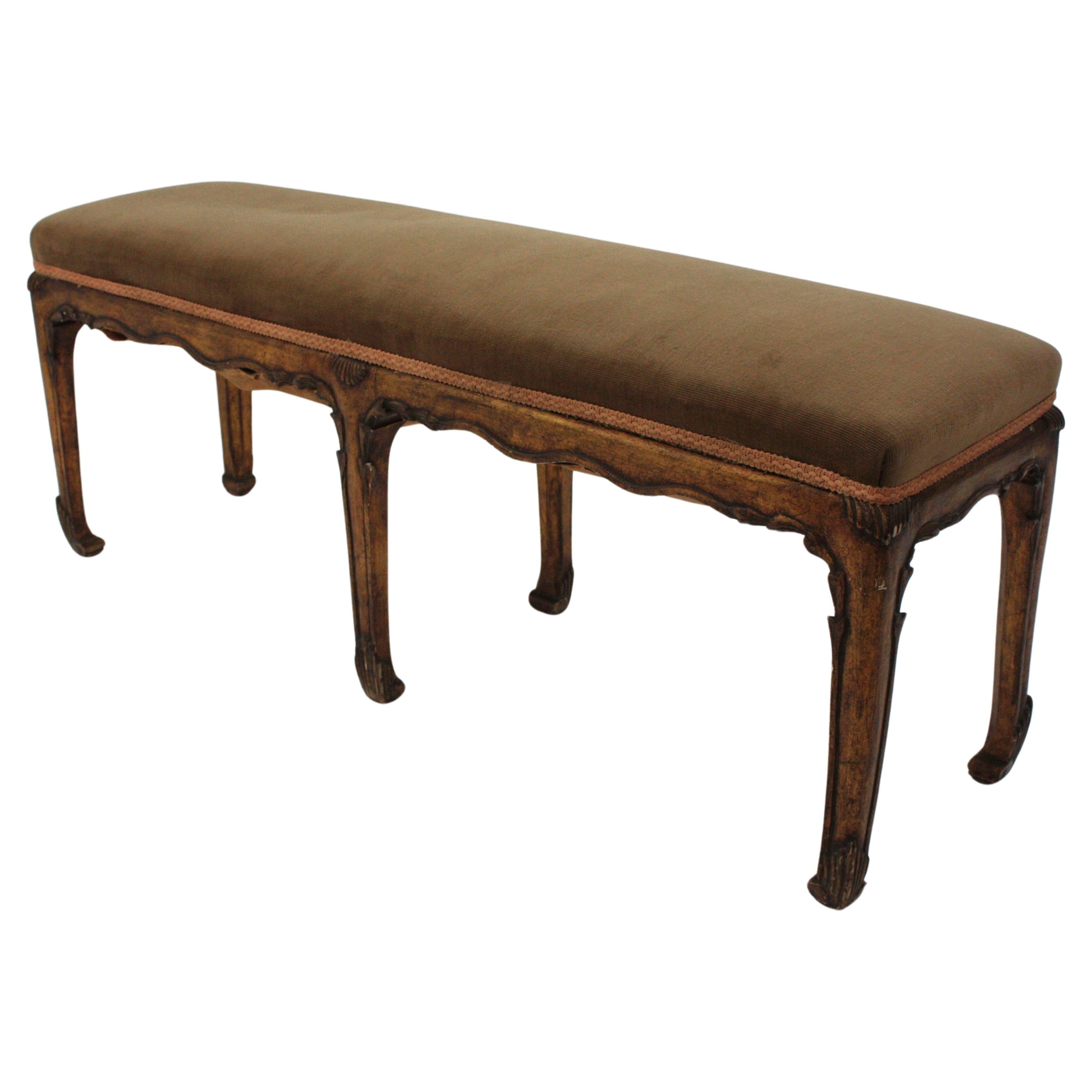 French Long Bench / Long Ottoman / Stool in Carved Giltwood, France, 1930s
Chinoiserie style upholstered bench in giltwood with carving details.
This bench or stool is raised on six legs with carved chinoiserie art deco motifs and gold leaf gilding.