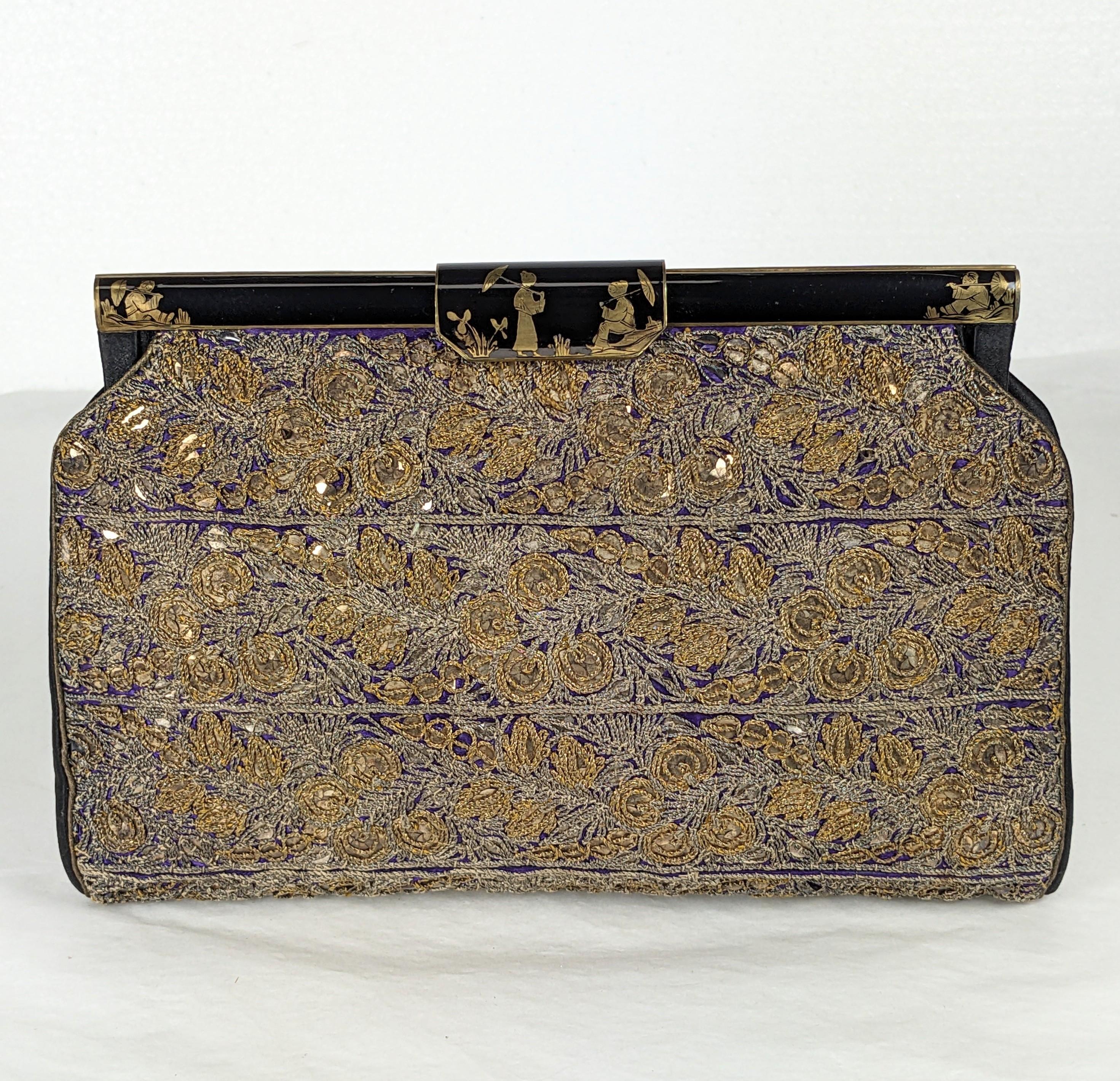 Amazing French Chinoiserie Embroidered Sequin Clutch with enameled silver frame. Beautifully hand embroidered with gold and silver tinsel threads over gold sequins on a vibrant purple satin. Enamel is hand painted with gilt Chinoiserie motifs. Black