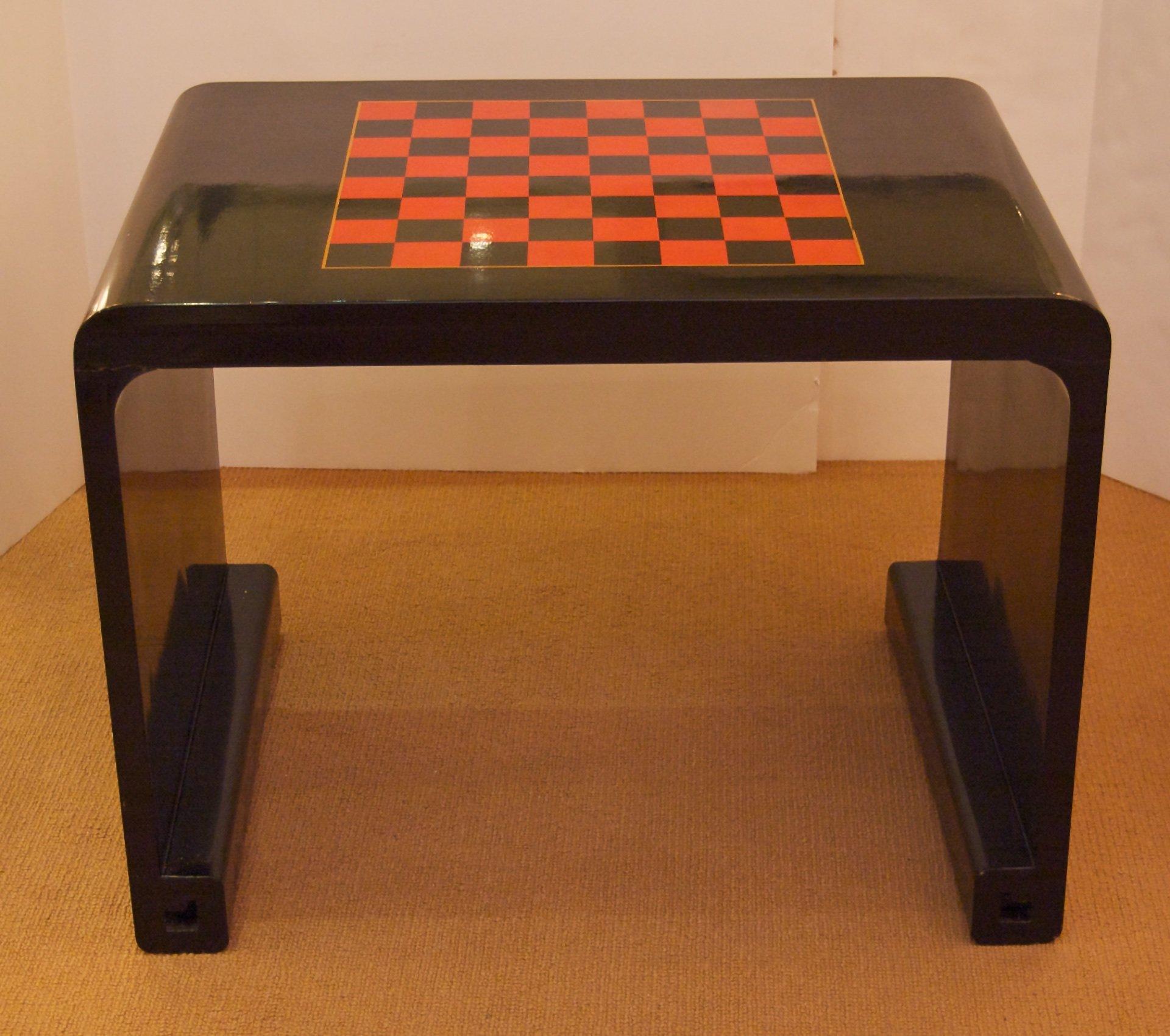Elegant chinoiserie French game table in black lacquer, with gilt detailing and a checkerboard pattern on the top.
Signed 1937.