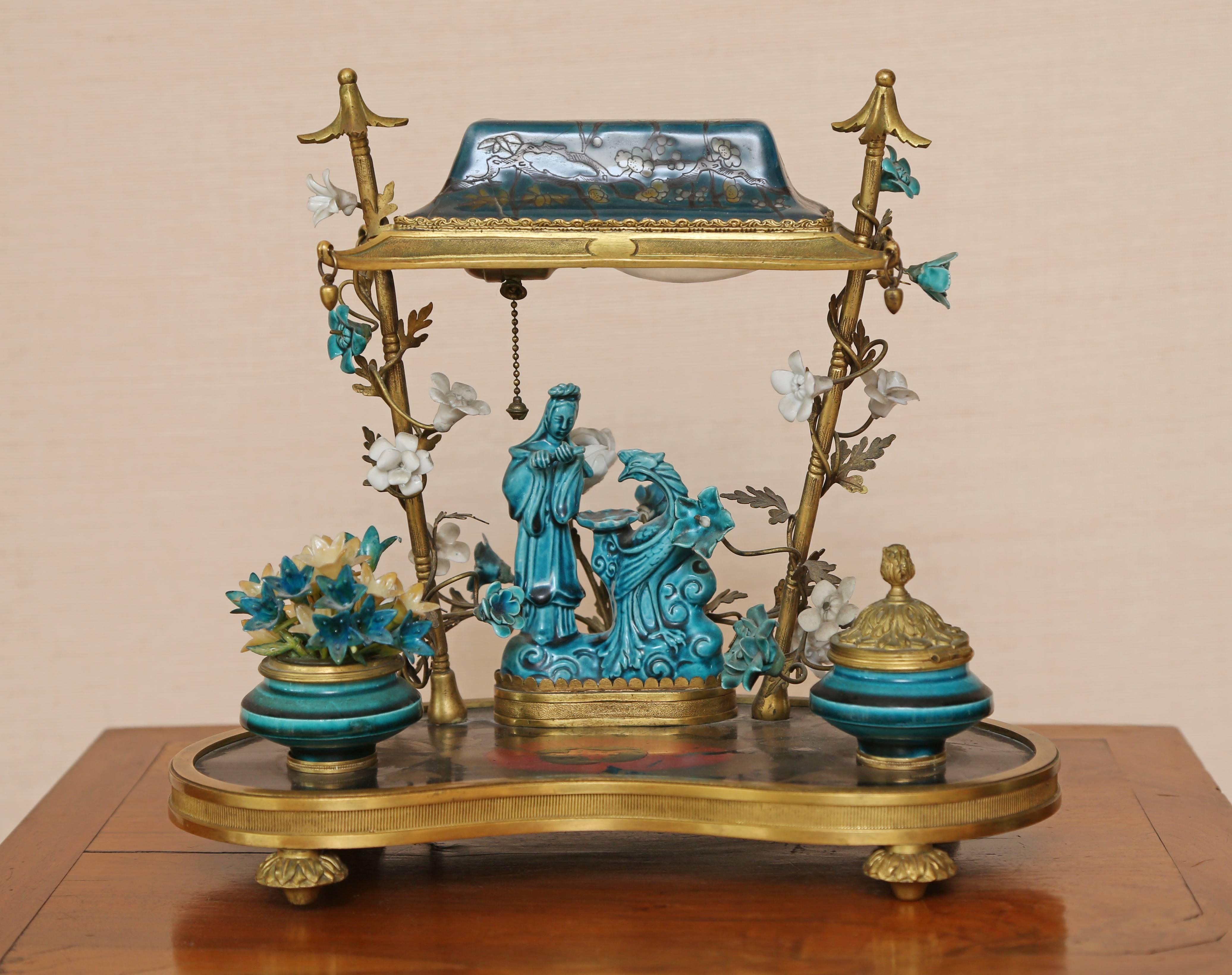The underside of the cherry-blossom decorated palanquin forming the shade over the court figure with phoenix resting on the gilt-bronze mounted carton Pierre panel.