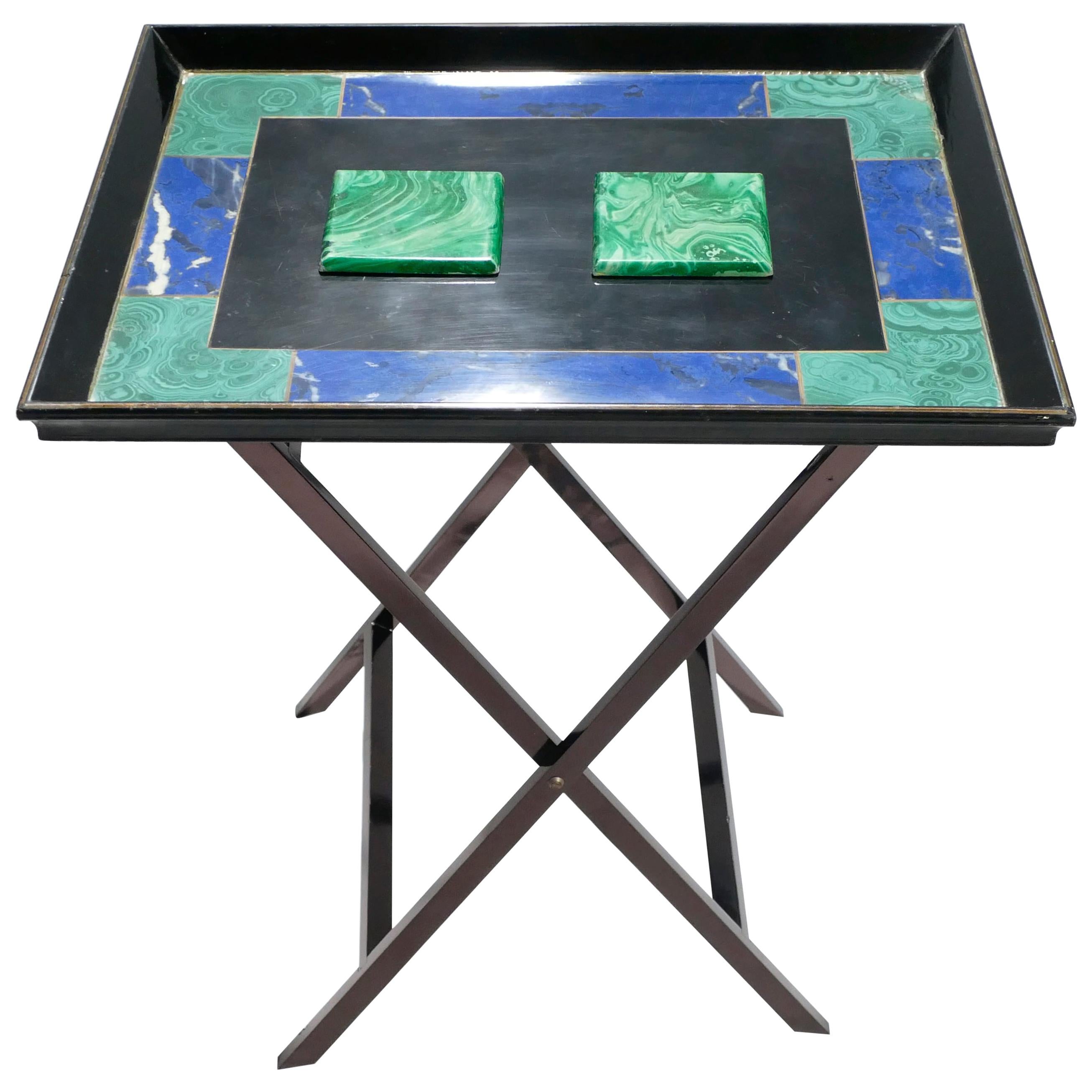 This folding tray table is a rare and unique piece from Christian Dior’s, 1970s line of furniture. For both the tray and the legs, wood is painted a smooth black. While the structure of the tray displays the traditional lines of Neoclassism, the