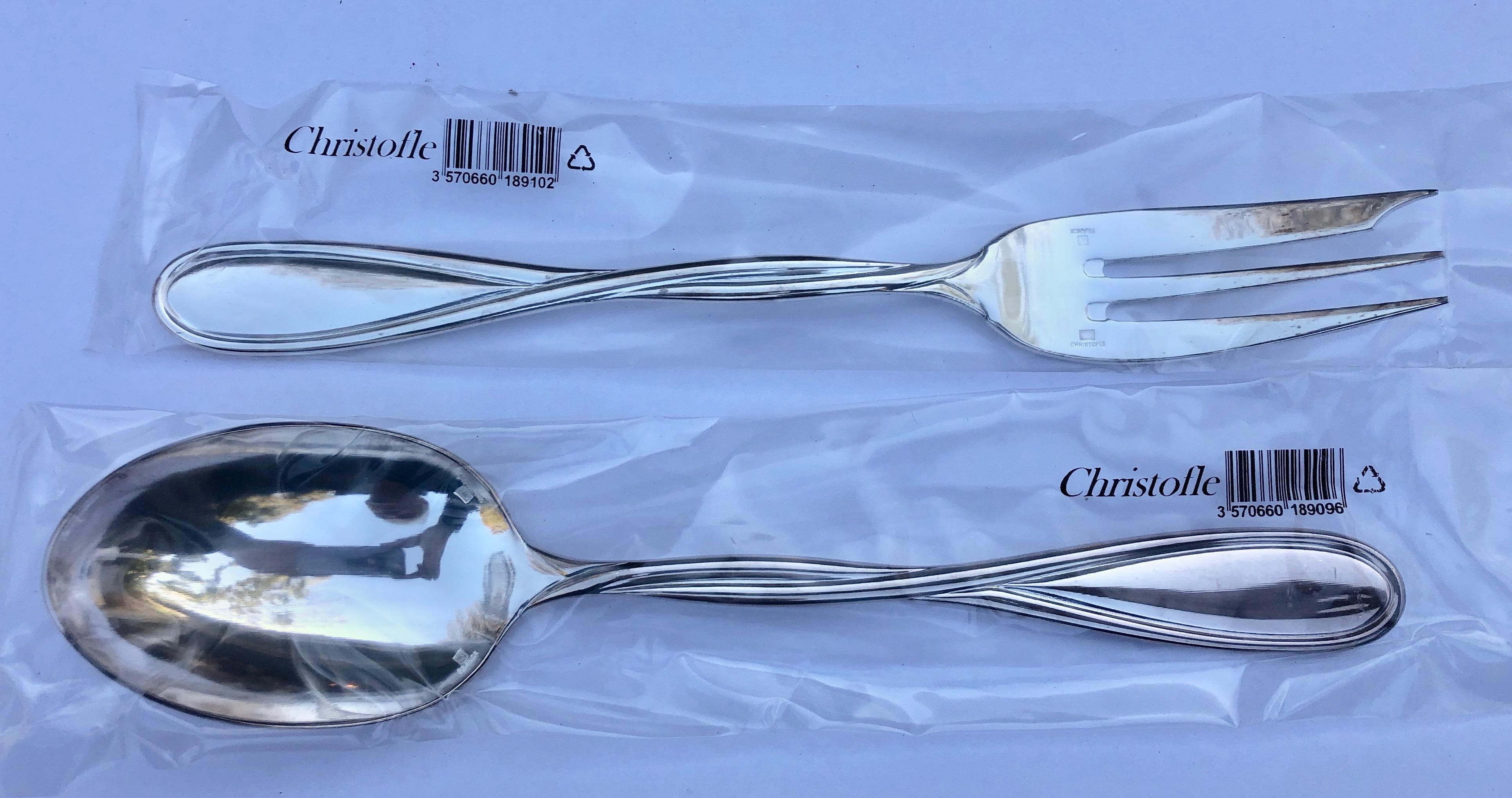 This is a beautiful French silver plated Christofle pair of serving fork and spoon. They have never been used, new, in their original wrapped plastic and box. The model is Galea.

Launched in 2000, the Galéa flatware collection features designer